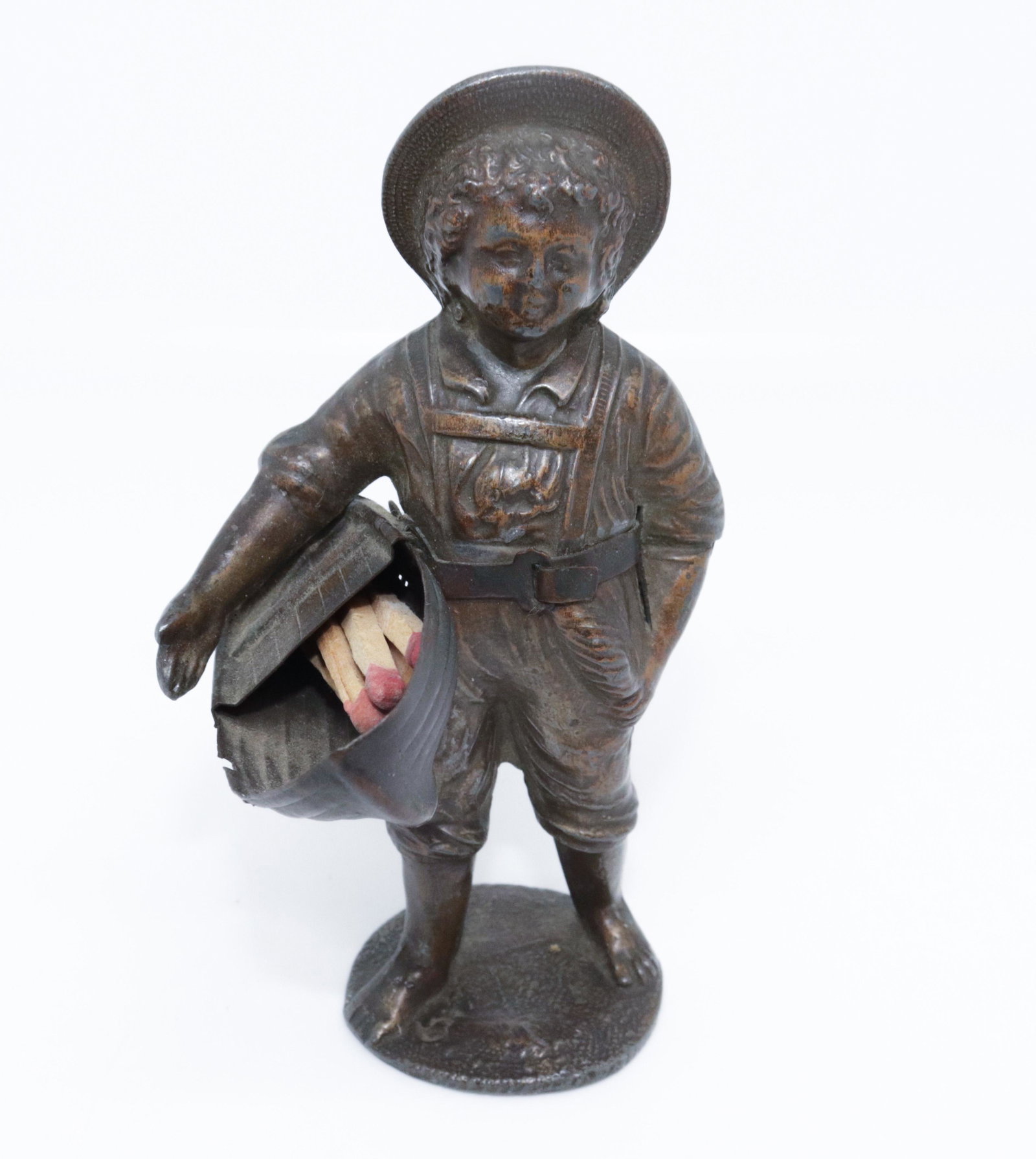 CAST METAL FIGURAL MATCH HOLDER: YOUNG BOY WITH TOY BOAT 4.75" H