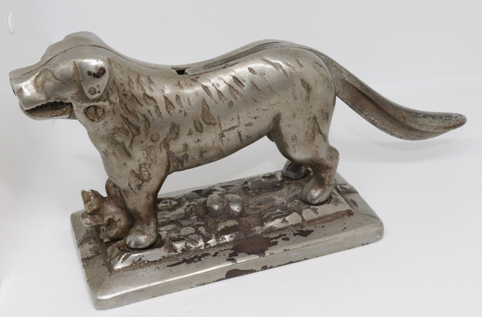 NICKELED CAST IRON DOG NUTCRACKER: HAS SMALL SQUIRREL AT BASE. NUMBERED 20 ON BOTTOM 12.5"L