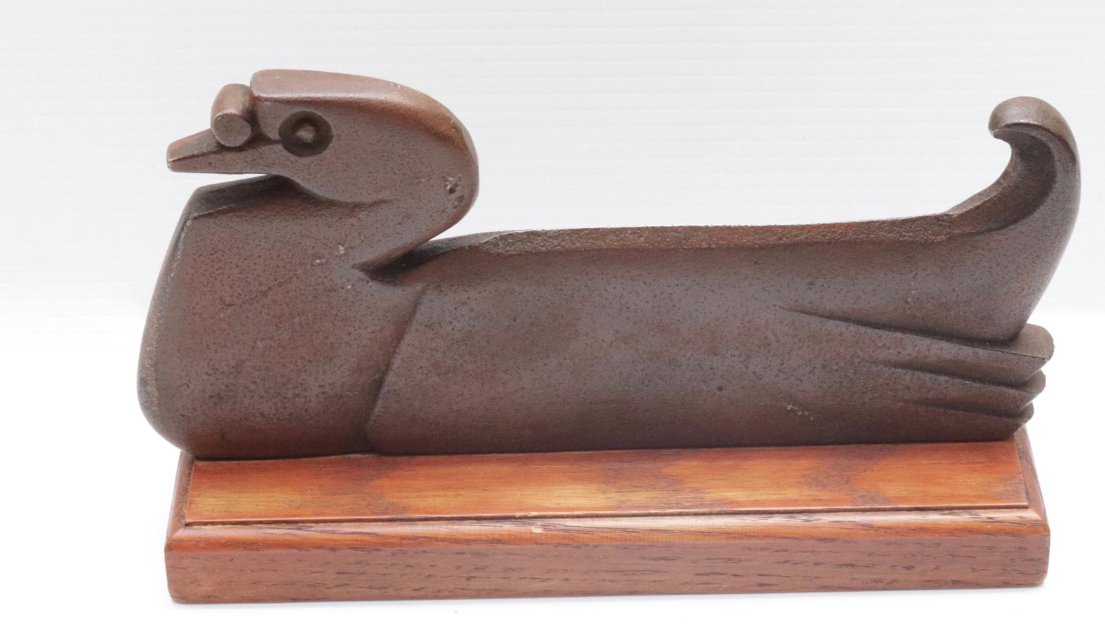CAST IRON DUCK BOOT SCRAPER: PAINTED SURFACE. MOUNTED ON WOODEN BASE 10.75" L