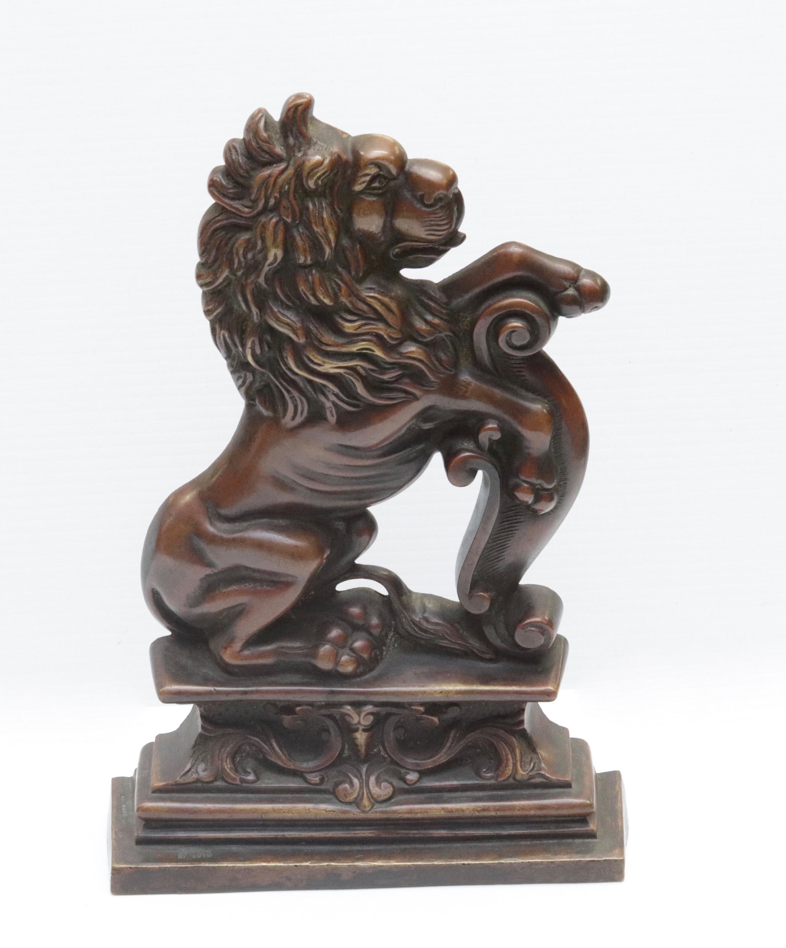 BRONZE LION DOORSTOP: LION ON PEDESTAL. LEAD FILLED BASE 13" H