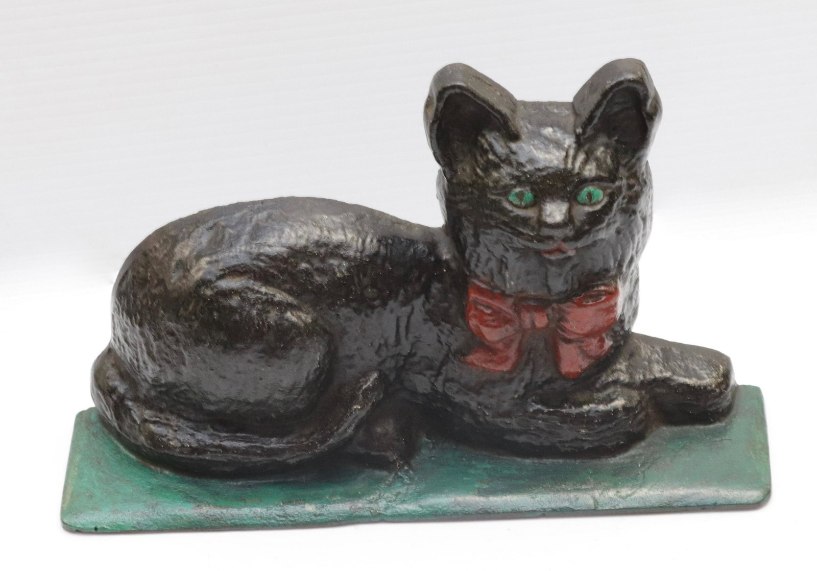 CAST IRON CAT DOORSTOP: LYING CAT. PAINTED SURFACE 6" H X 10.75" L