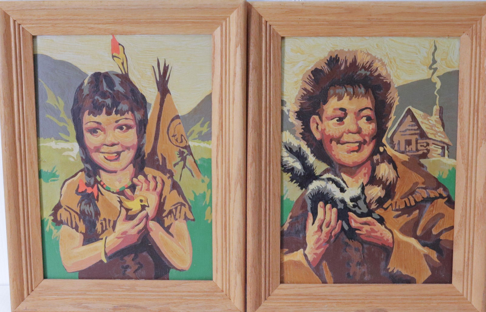 PAIR OF PAINT BY NUMBERS: BOY WITH RACCOON CAP AND INDIAN GIRL WITH BIRD Size: 17" X 13" TOTAL SIZE
