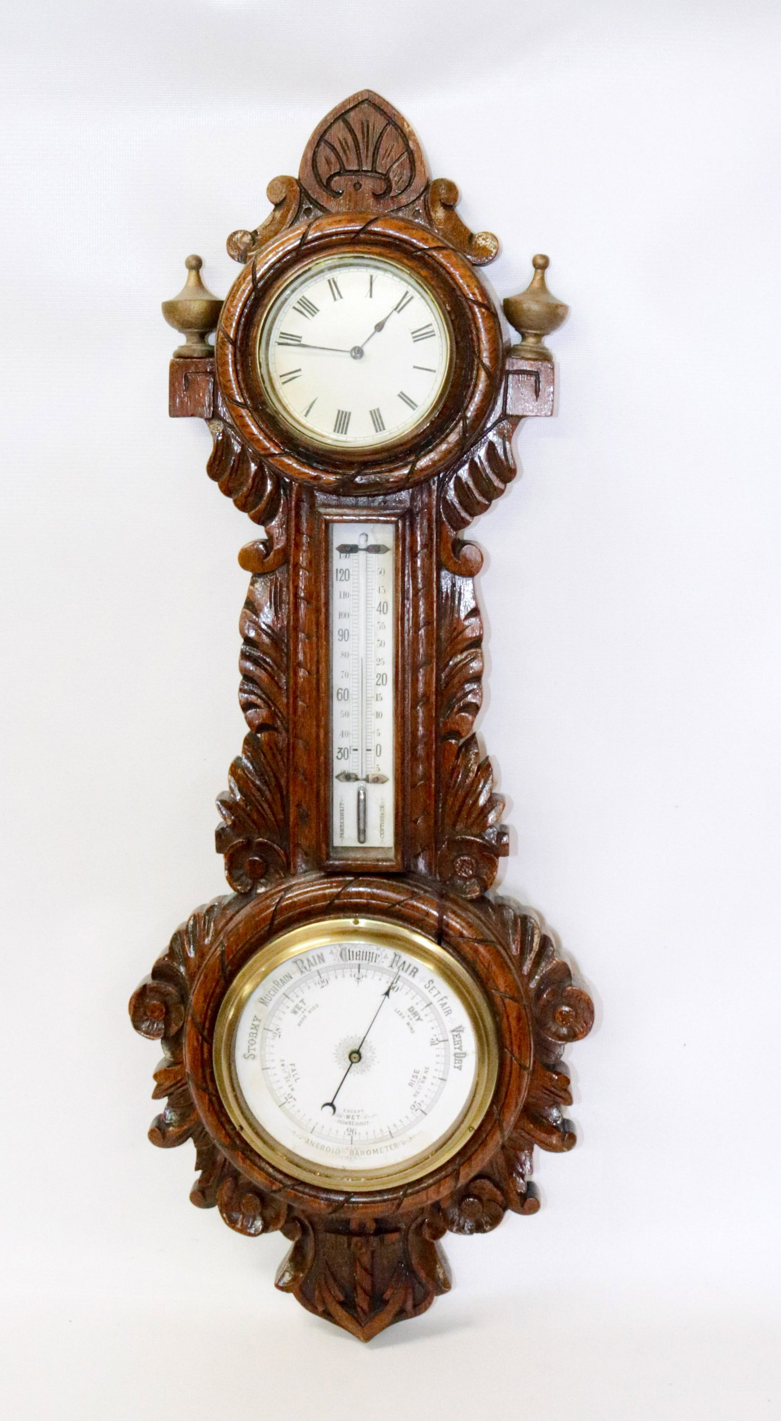ANEROID BAROMETER CLOCK: CLOCK, THERMOMETER AND BAROMETER MOUNTED ON CARVED WOODEN BACK WITH ANCHOR AT BOTTOM 26" L