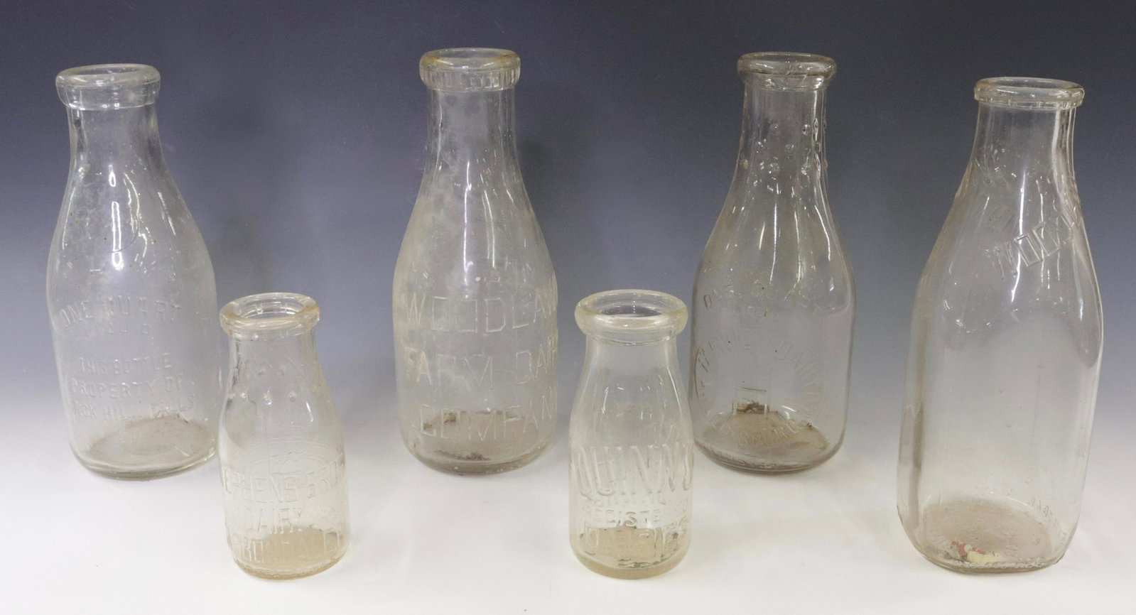 GROUP LOT OF VINTAGE MILK BOTTLES: (6) EMBOSSED BOTTLES. FAIRVIEW, PHILLIPSBURG, NJ. BUCK HILL FALLS. TWO WOODLAWN AND MORE Dimensions 5.5" TO 9.5" H