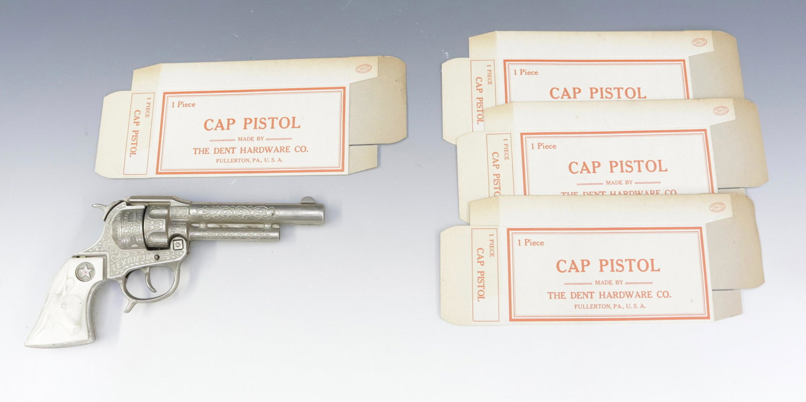 CAP GUN WITH (4) NOS BOXES: CAP GUN MRKD. TEXAN JR. WITH FOUR DENT HARDWARE UNUSED BOXES Dimensions CAP GUN 9.5" L