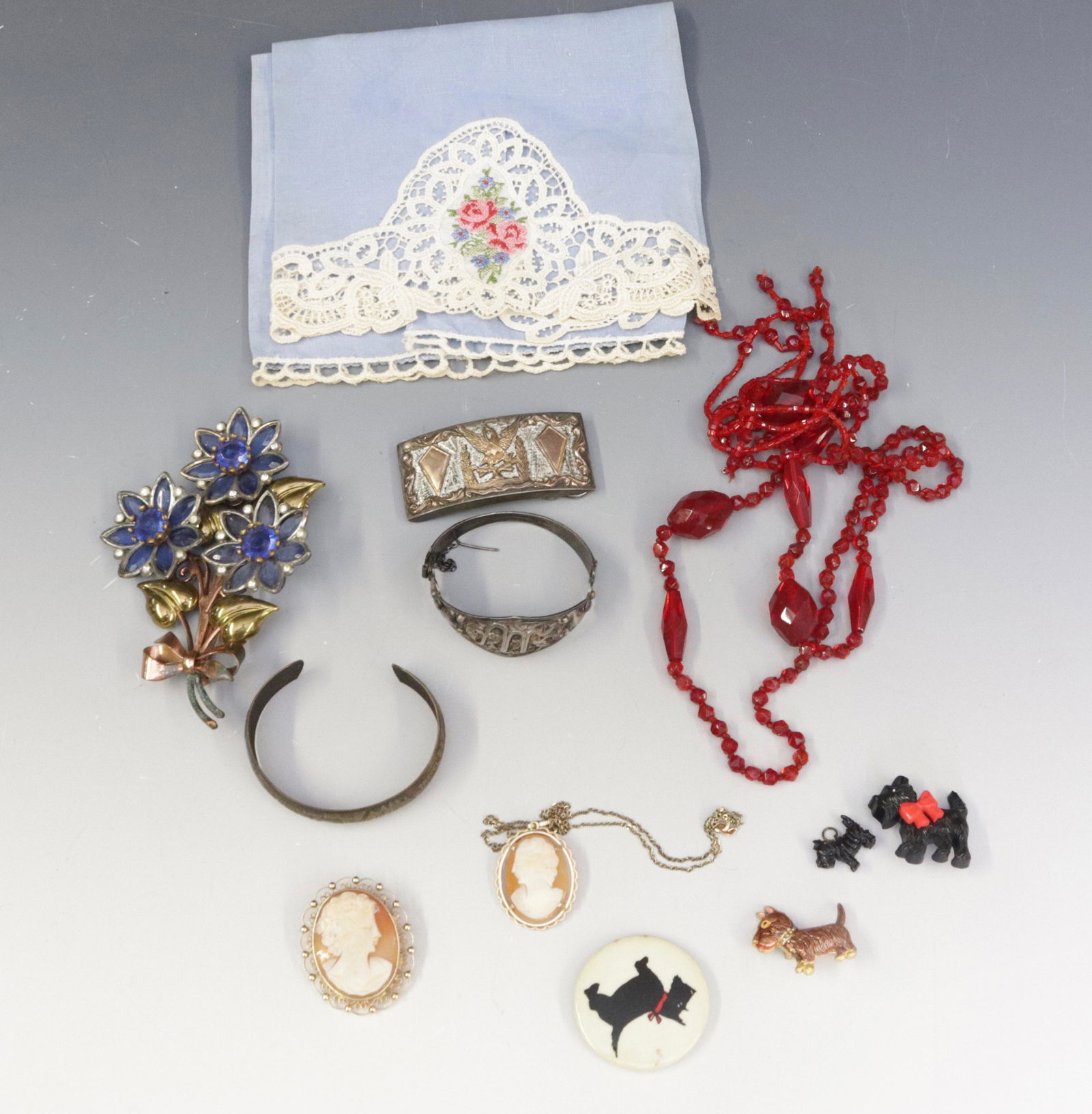 GROUP LOT OF COSTUME JEWELRY: INCLUDING: STERLING SILVER BUCKLE WITH EAGLE, 1934 WORLD'S FAIR CHICAGO BRACELET, SCOTTY DOG PINS AND MORE Dimensions BUCKLE MEASURE 2.25" X 1"