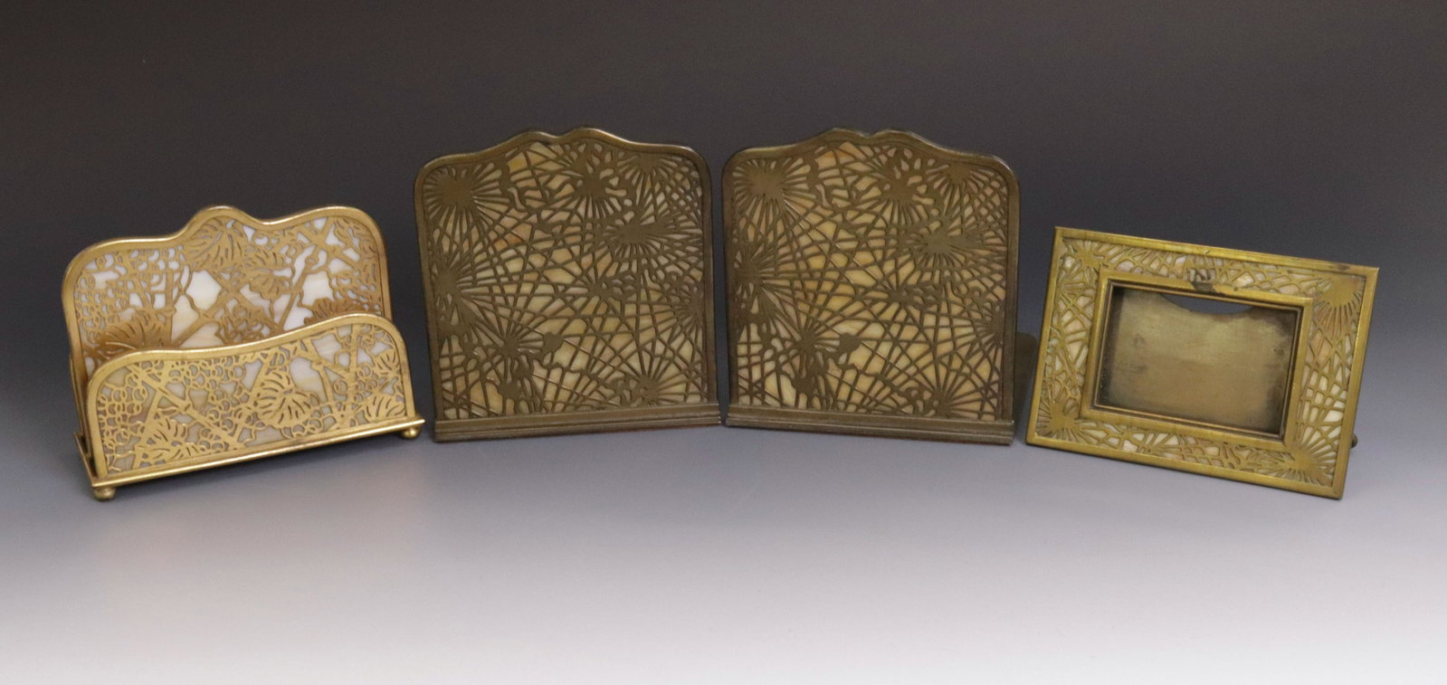 TIFFANY STUDIOS DESK SET: TIFFANY STUDIOS NEW YORK - CALENDAR STAND (941), BOOKENDS (1024) PINE NEEDLE PATTERN , AND LETTER HOLDER IN GRAPEVINE PATTERN (#1019) FRAME 4" X 6" - BOOKENDS 6" X 5 3/4" - LETTER HOLDER 4 3/4" X 6"