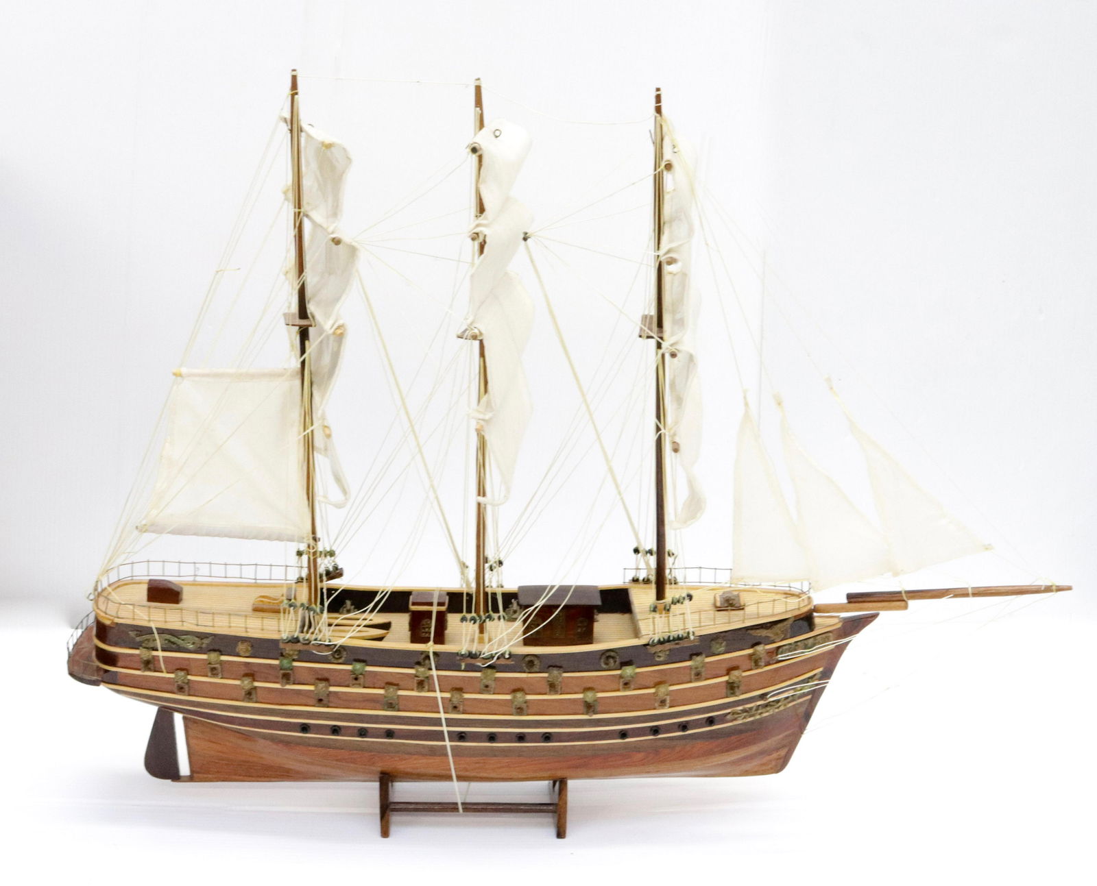 WOODEN GALLEON MODEL: THREE MASTED WITH COTTON SAILS (PLASTIC BACKED). PAINTED DETAILS 24" X 32"