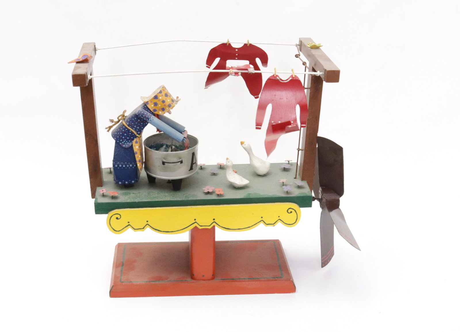 FOLK ART WHIRLIGIG: HAND PAINTED WOOD AND METAL. TITLED "RITES OF SPRING" SGND. CR '78 15" X 17" X 10"