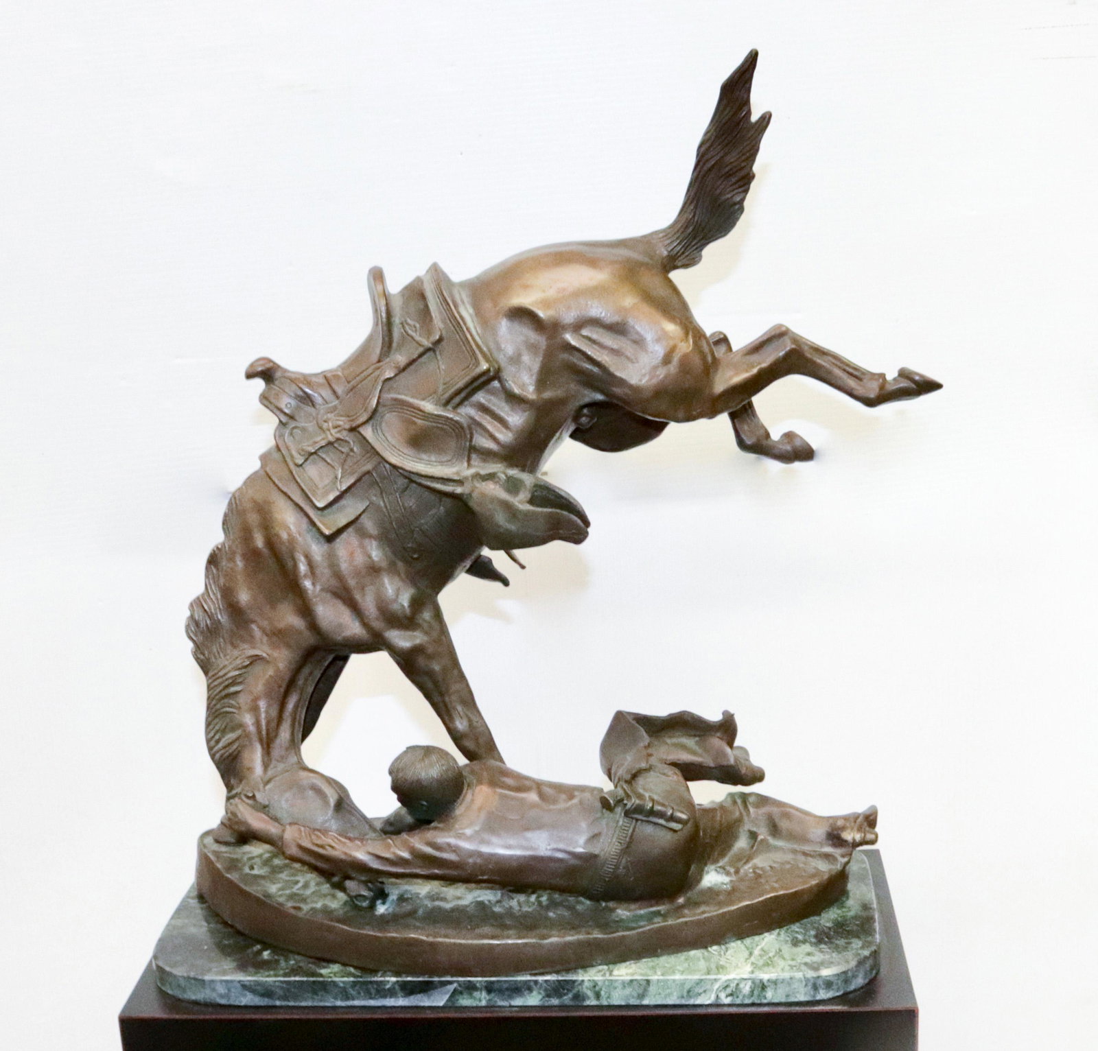 AFTER FREDERIC REMINGTON BRONZE: "THE WICKED PONY". SGND. FREDERIC REMINGTON. ON MARBLE PLINTH. 20 1/2" H X 22"