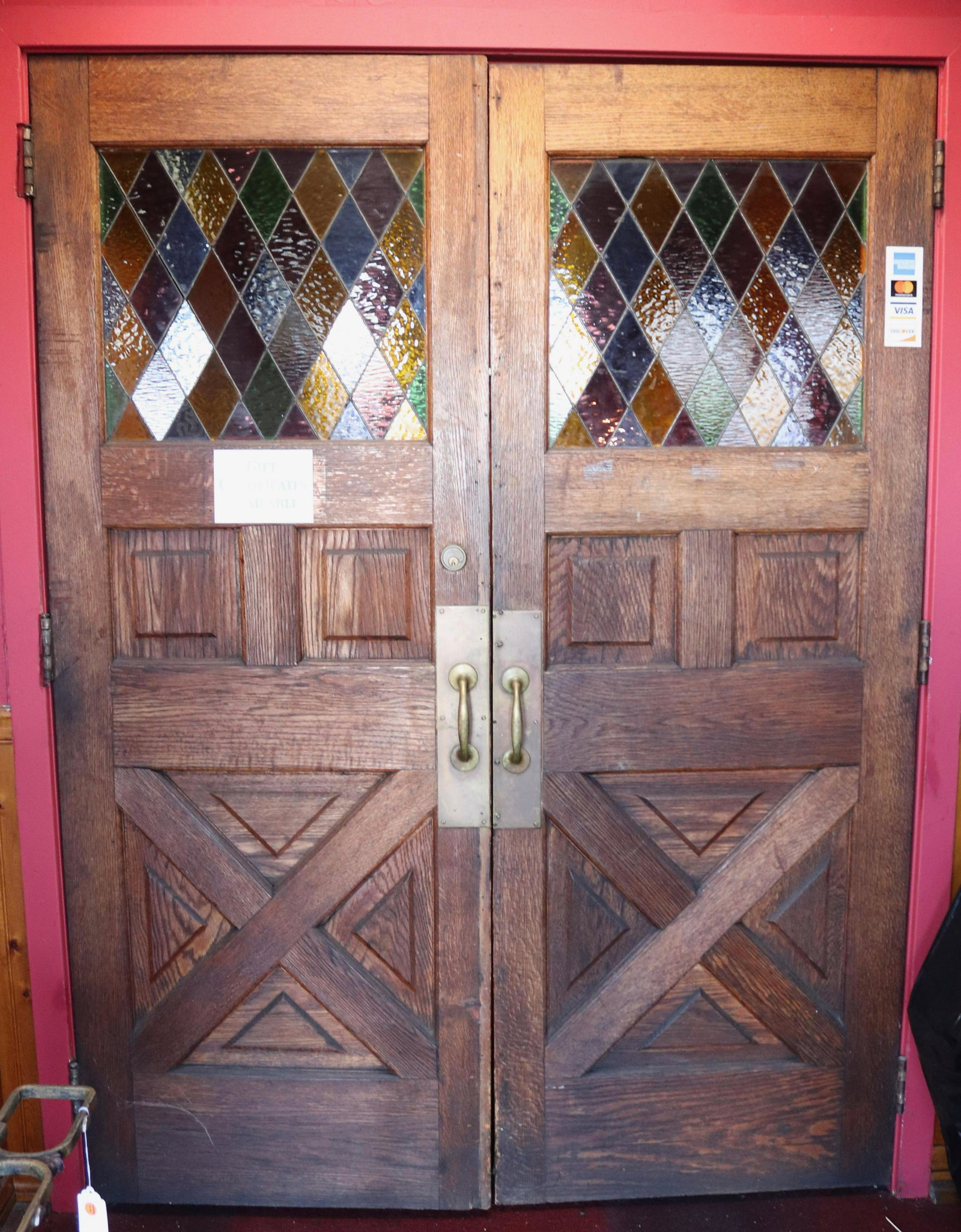 PAIR OF INTERIOR ENTRYWAY DOORS: PANELED WOOD WITH COLORED LEADED GLASS. BRASS PULLS Size 79" X 29 1/4" Disclaimer PLEASE READ BEFORE BIDDING!!! Pick-up will be Tuesday January 5th, 2021 from 9:00am till 5:00pm and Thursday January 7