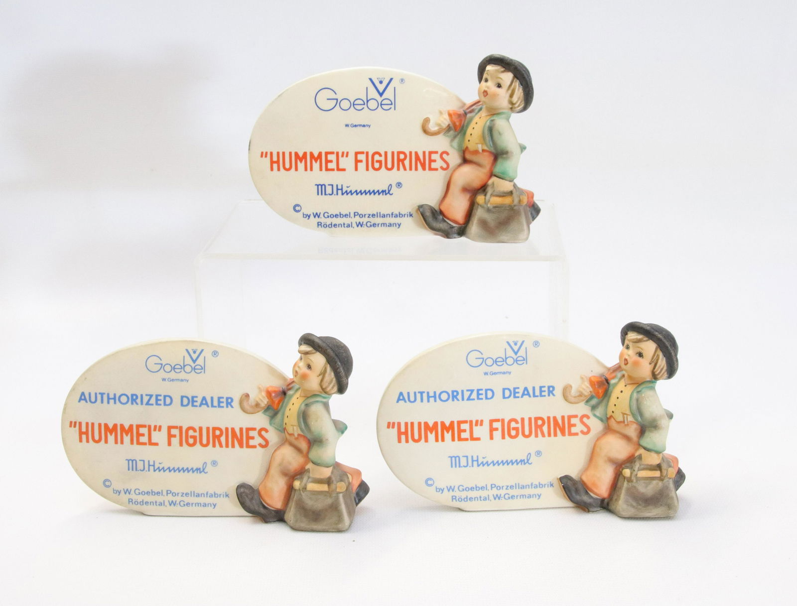 GROUP LOT OF GOEBEL HUMMEL DEALER SIGNS: THREE SIGNS WITH MERRY WANDERER Size 3 1/2" X 5 1/2"