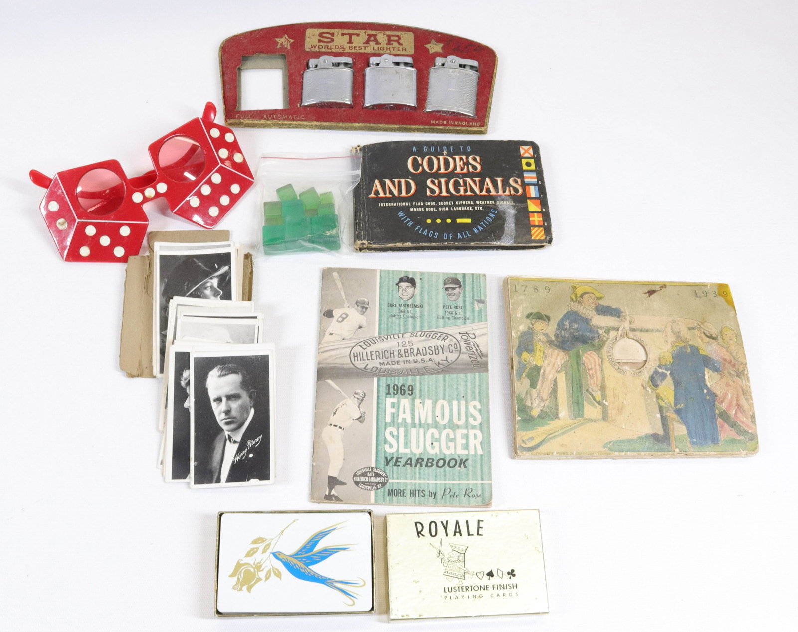 GROUP LOT OF VINTAGE SMALLS: INCLUDING: STAR LIGHTERS, PLAYING CARDS, SUNGLASSES, 1969 FAMOUS SLUGGER YEARBOOK AND MORE Dimensions LIGHTER DISPLAY 8 3/4" L