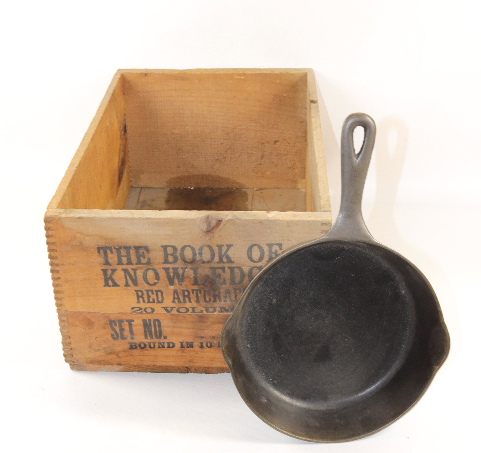 CAST IRON PAN AND ADVERTISING CRATE: DOVETAILED CRATE MRKD. THE BOOK OF KNOWLEDGE Dimensions PAN IS 8" D. CRATE 10 3/4" X 16 1/4"