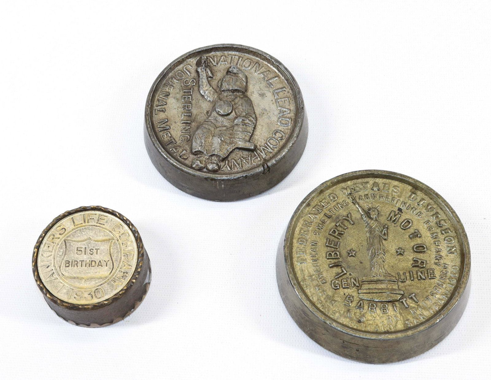 GROUP OF ADVERTISING PAPERWEIGHTS: INCLUDING: LIBERTY MOTOR (LEAD), NATIONAL LEAD COMPANY (LEAD) AND BANKERS LIFE COMPANY 1930 (BRASS) Dimensions 2 1/4" TO 4"