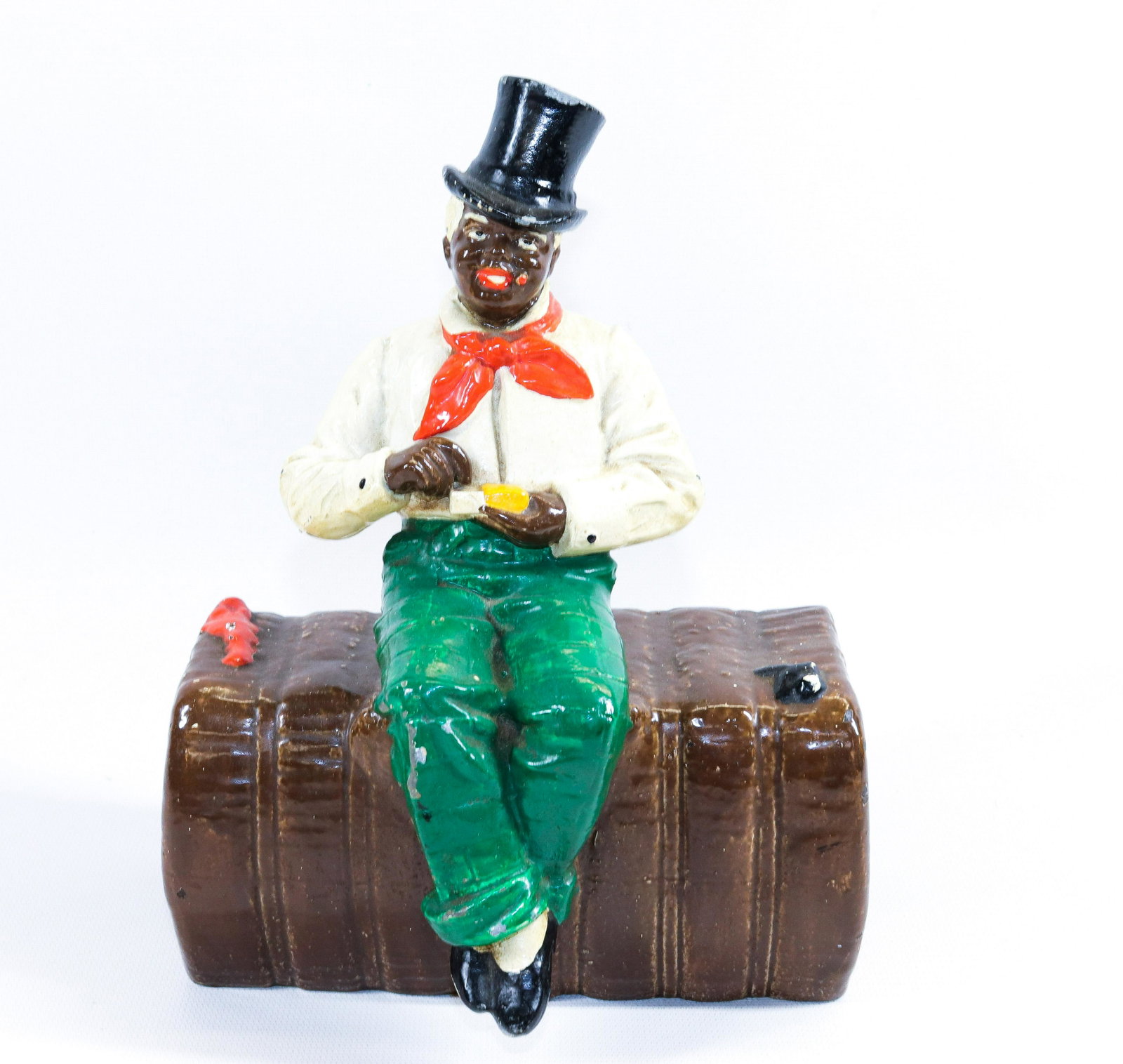 MAN ON BALE OF COTTON DOORSTOP: PAINTED SURFACE. WHITE METAL MINSTREL FIGURE ON CAST IRON BALE Dimensions 9" X 6 1/2"