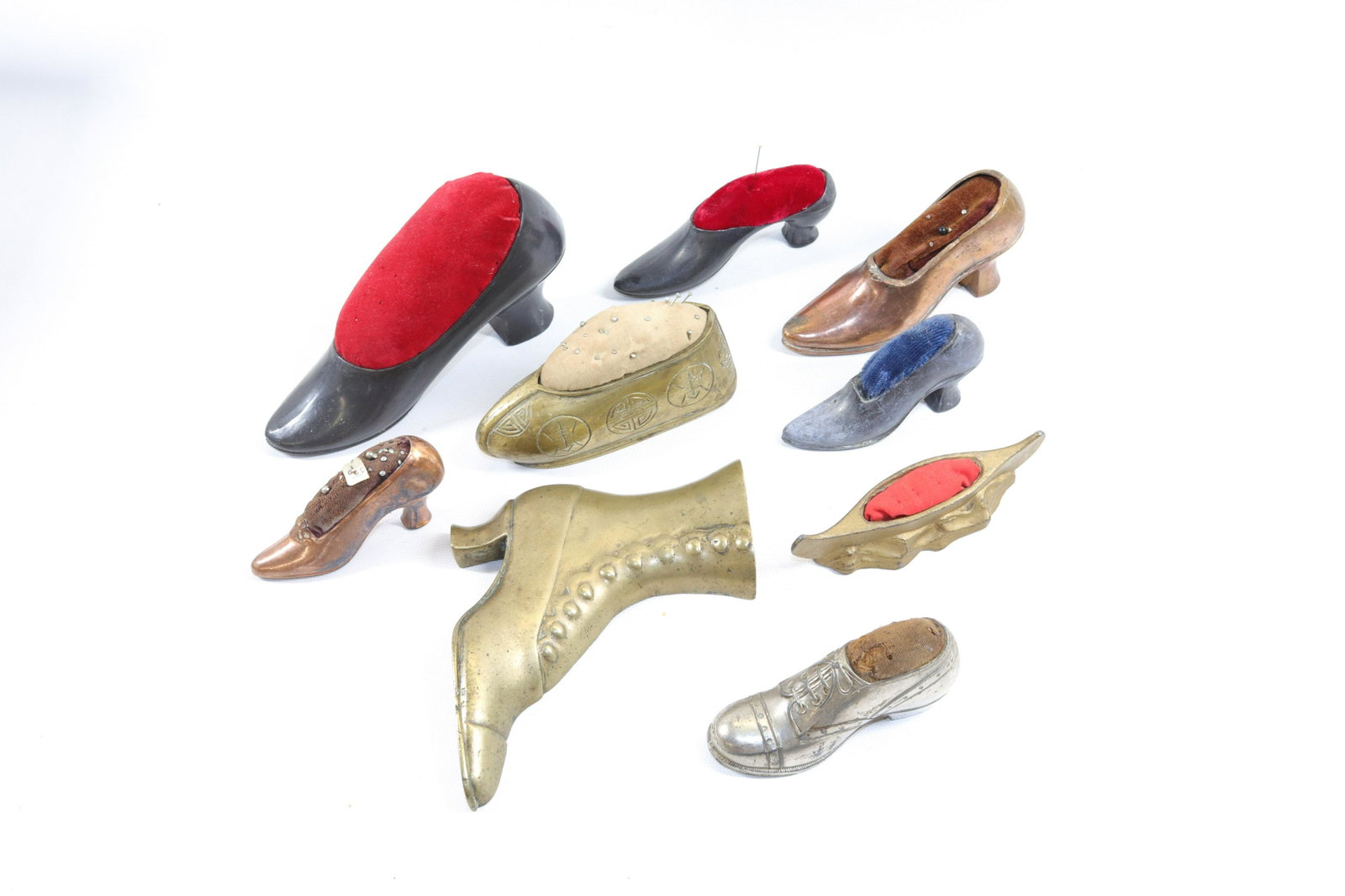 GROUP LOT OF SHOE PIN CUSHIONS: (7) SHOES, ONE CANOE AND ONE DECORATIVE BRASS HIGH BUTTON SHOE Dimensions 3 1/4" TO 6" L