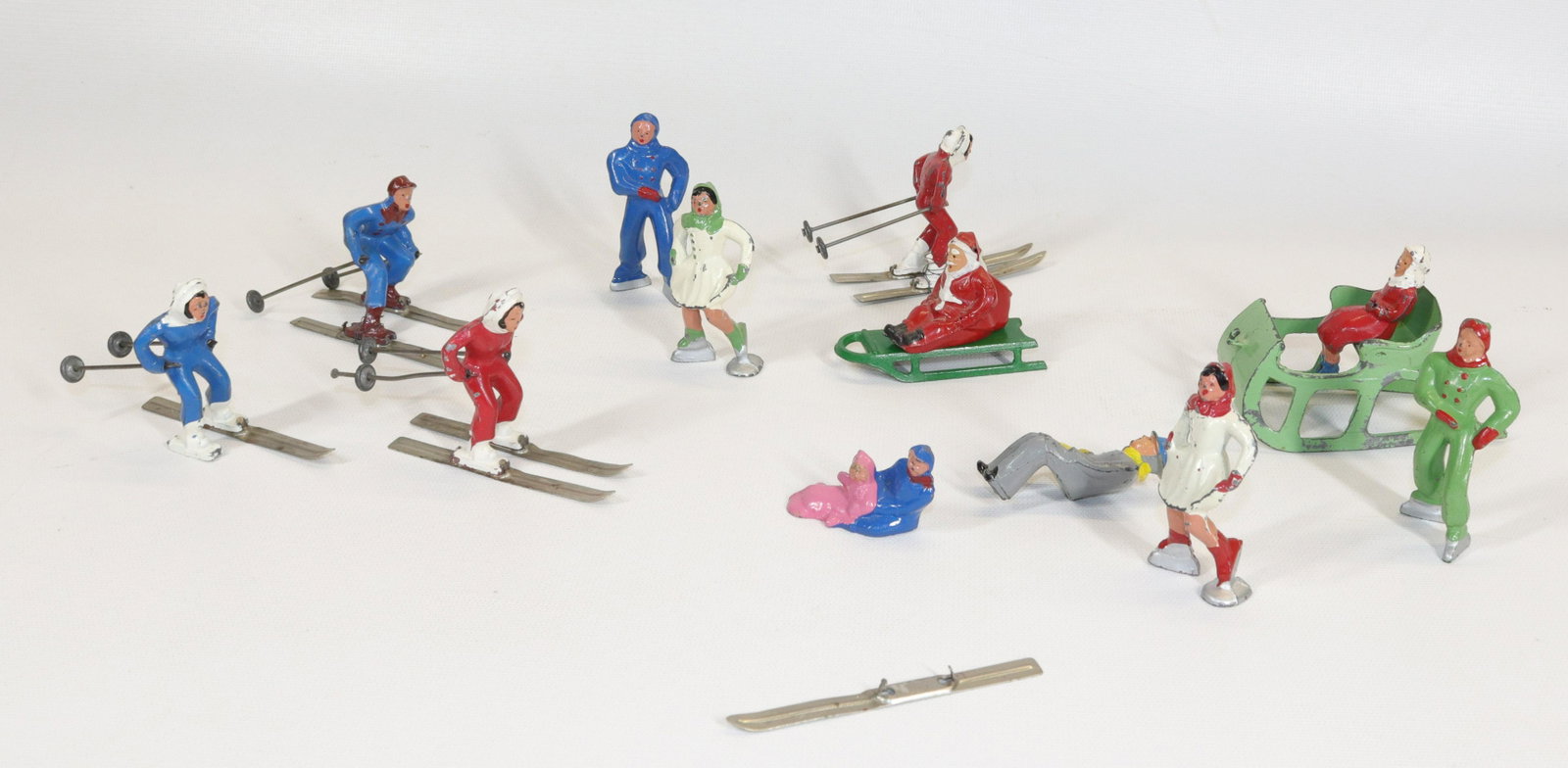 GROUP LOT OF LEAD BARCLAY FIGURES: FOUR SKIERS, FOUR ICE SKATERS, COUPLE IN SLEIGH, SANTA ON SLED, AND PAIR OF KIDS