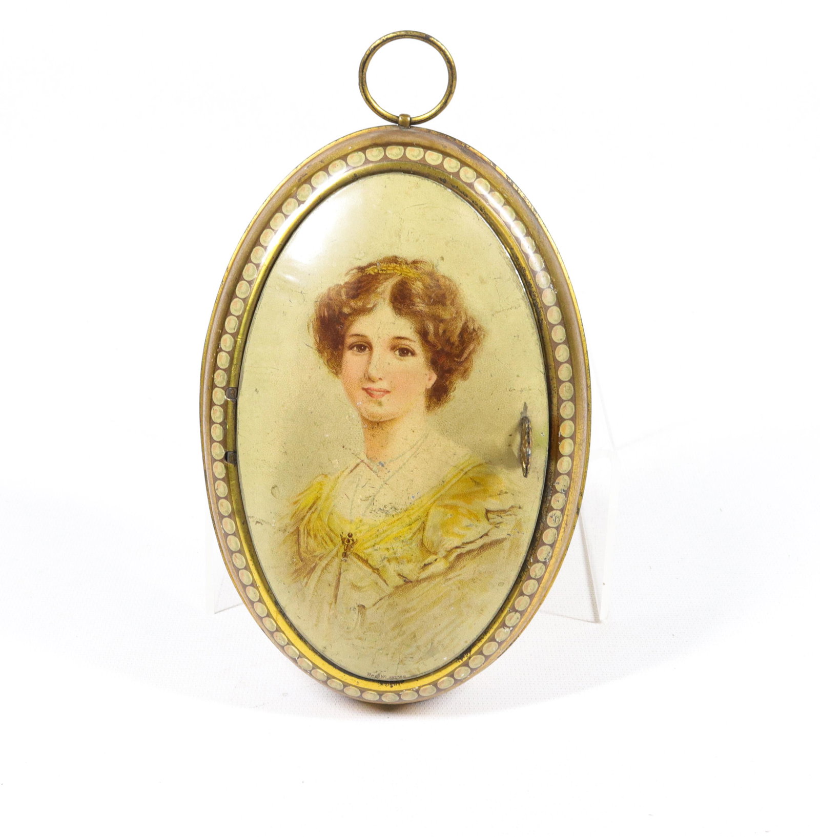 HUNTLEY AND PALMERS BISCUIT TIN: LOCKET" - OVAL TIN WITH LIFT FRONT - CIRCA 1912 7" X 4 3/4