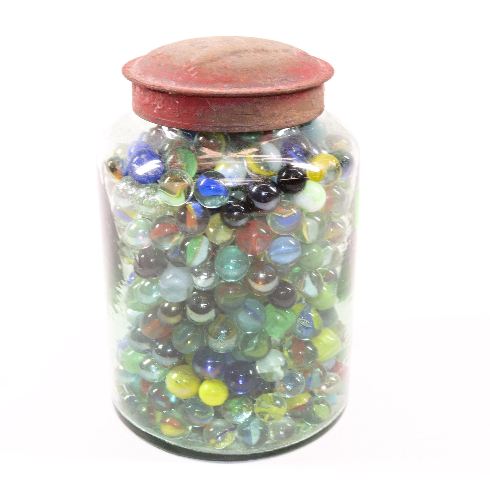 BLOWN GLASS STORAGE JAR WITH MARBLES: JAR HAS PAINTED TIN LID. FILLED WITH GLASS MARBLES Size: 7 3/4" H