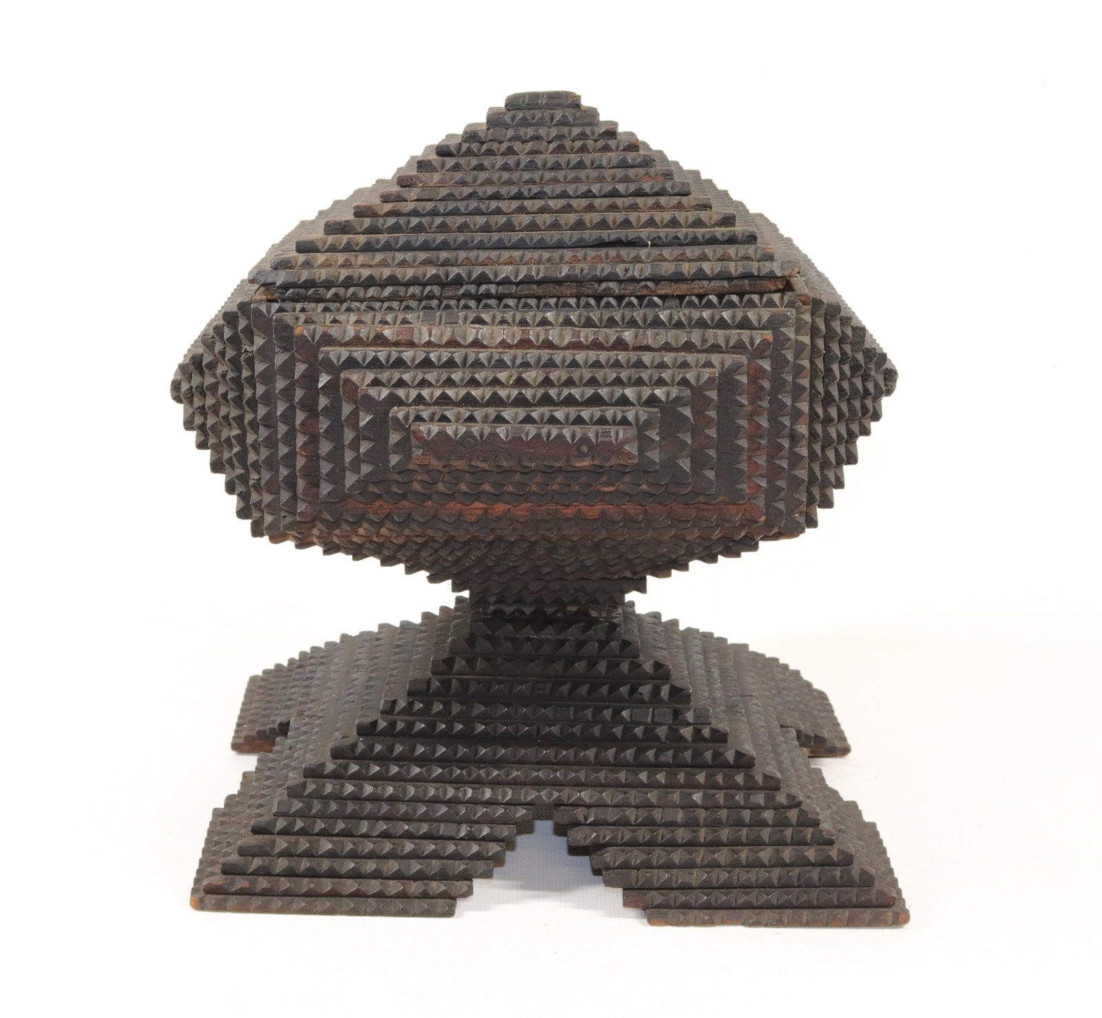 CHIP CARVED FOLK ART PEDESTAL BOX: TRAMP ART BOX IN DARK STAIN ON LAYERED BASE. CONSTRUCTED FROM CIGAR BOXES. LIFT OFF LID. Size: 10" X 9" X 7 1/4"