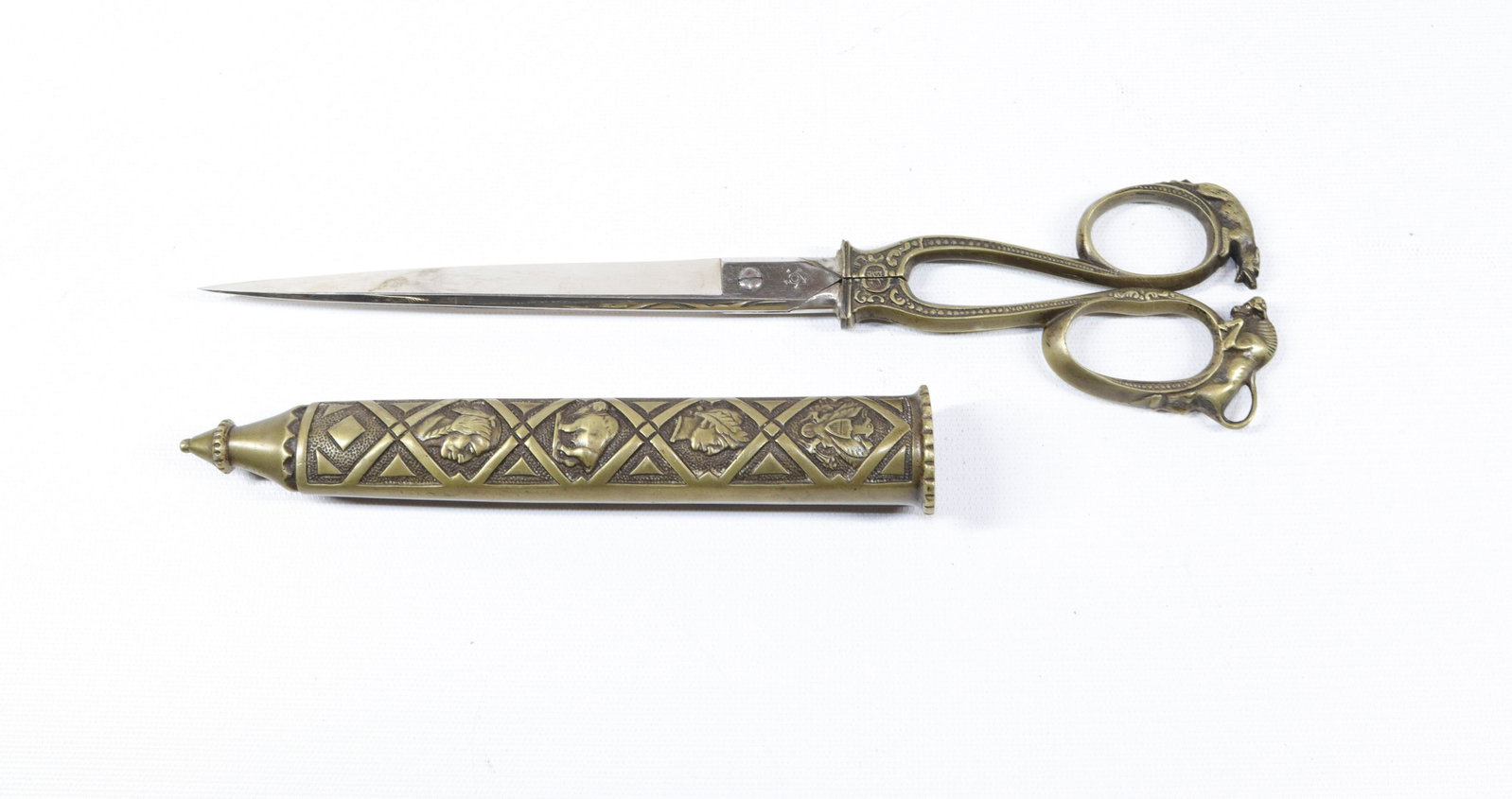 PAIR OF GERMAN BRASS SCISSORS IN SHEATH: MRKD. DARTRING GERMANY. BRASS FINGER HOLES HAVE BULL AND WOLF. SHEATH IS DECORATED WITH EAGLE, BUFFALO, INDIAN AND MAN WITH LAUREL WREATH Size: 10 3/4" L. TOTAL LENGTH IS 11 1/2"