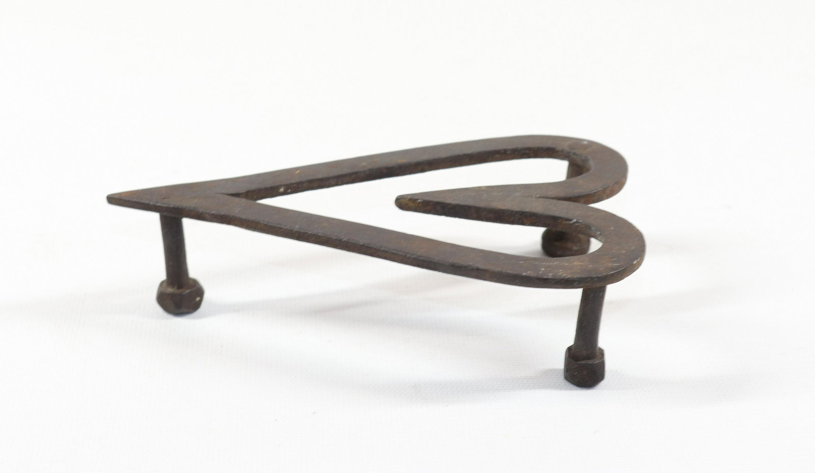 WROUGHT IRON HEART TRIVET: THREE LEGGED TRIVET IN HEART FORM. PENNSYLVANIA Size: 1 1/2" X 6"