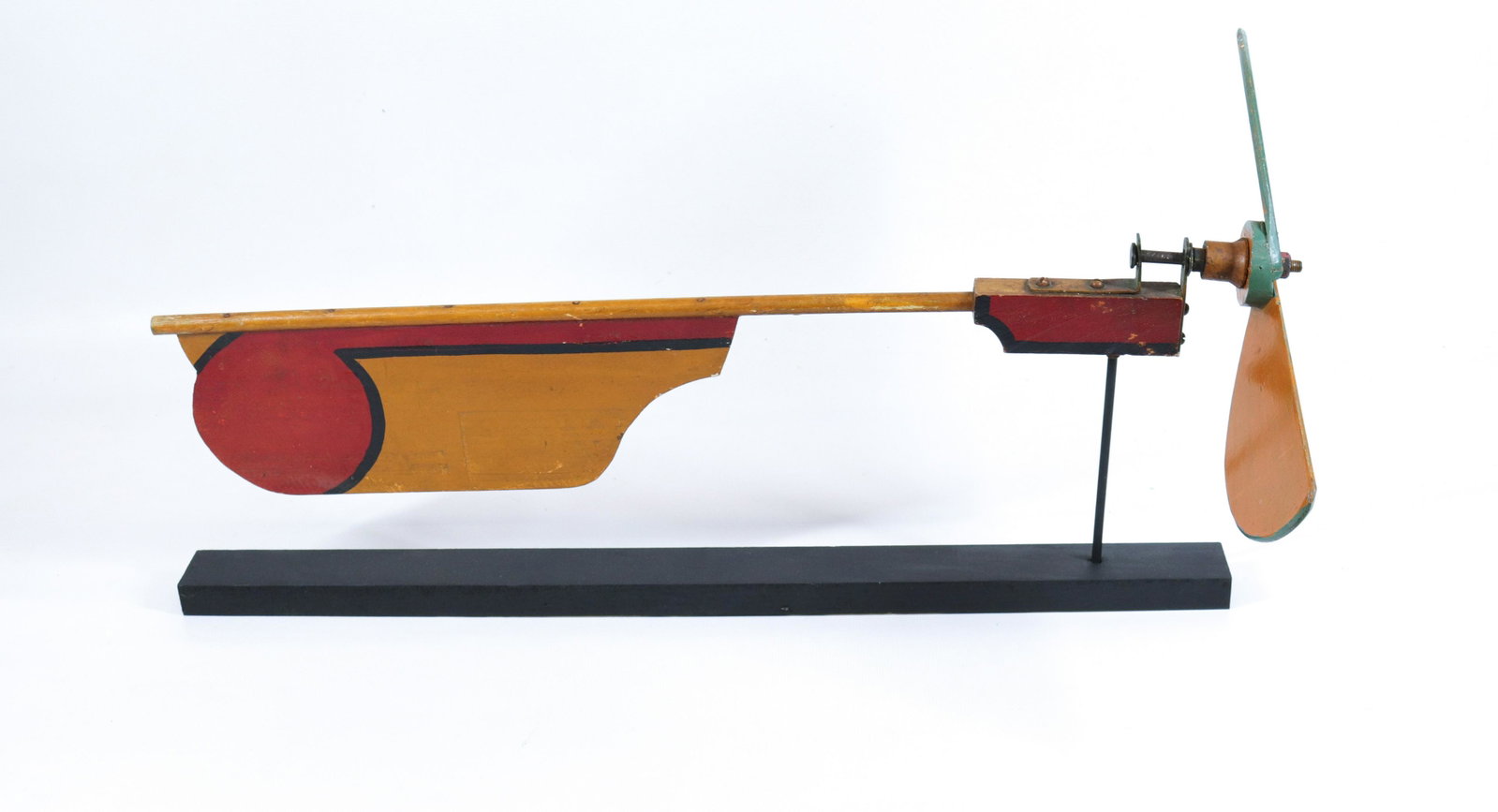 PAINTED WOODEN WHIRLIGIG: ORANGE, RED AND BLACK. MOUNTED ON MODERN BASE Size: 8 1/2" X 21 1/2"