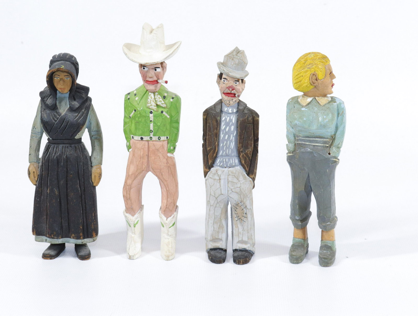 JAILHOUSE CARVING LOT: (4) HAND CARVED AND PAINTED FIGURES INCLUDING - HOBO, AMISH WOMAN, COWBOY, AND BREASTED WOMAN Size: 5 3/4" TO 6 1/2" H