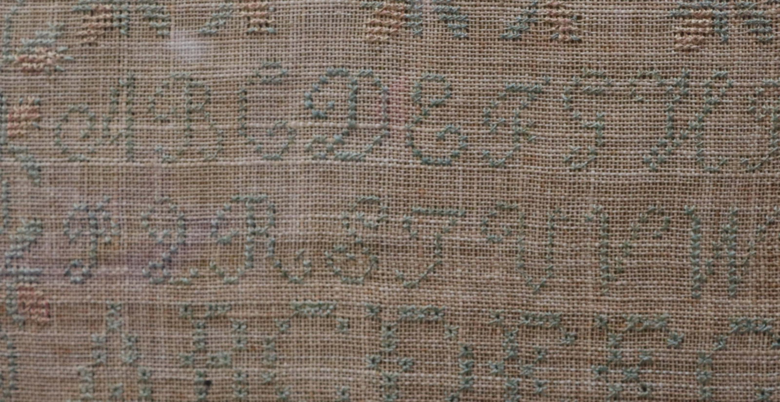 19TH CENTURY FRAMED SAMPLER: BY; ELIZABETH W. BACON - BORN; JULY 6TH, 1812 - WRIGHT IN THE SUMMER OF 1824 AND INSTRUCTED BY; L. MERRITT - INCLUDES ALPHABETS, NUMBERS, AND VERSE WITH FLORAL BORDER Size: SAMPLER SIZE 17" X 16 3/4"