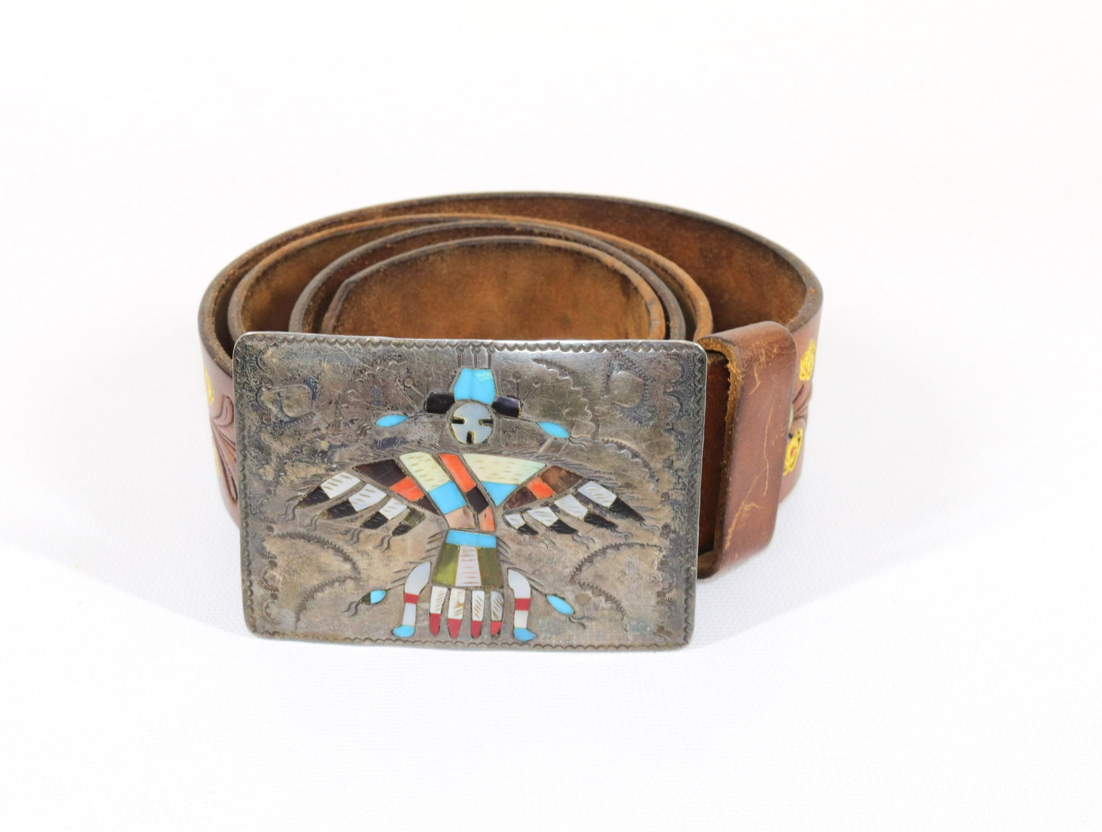 NATIVE AMERICAN SILVER BUCKLE AND BELT: NAVAJO HALLMARK "RICHARD BEGAY" - SILVER BUCKLE WITH INLAID FIGURE, AND LEATHER BELT Size: BELT 44" L - BUCKLE 2 1/2" X 3 1/2"