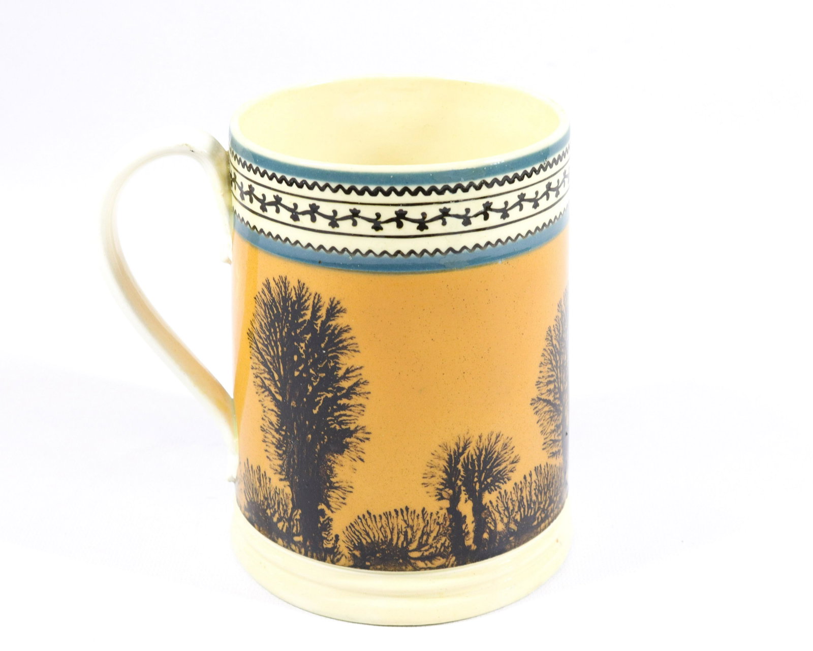 MOCHAWARE MUG: ORANGE ROUND WITH BLACK SEAWEED DECORATION. TWO BLUE BANDS WITH BLACK DESIGN AROUND TOP Size: 5 1/2" X 4"