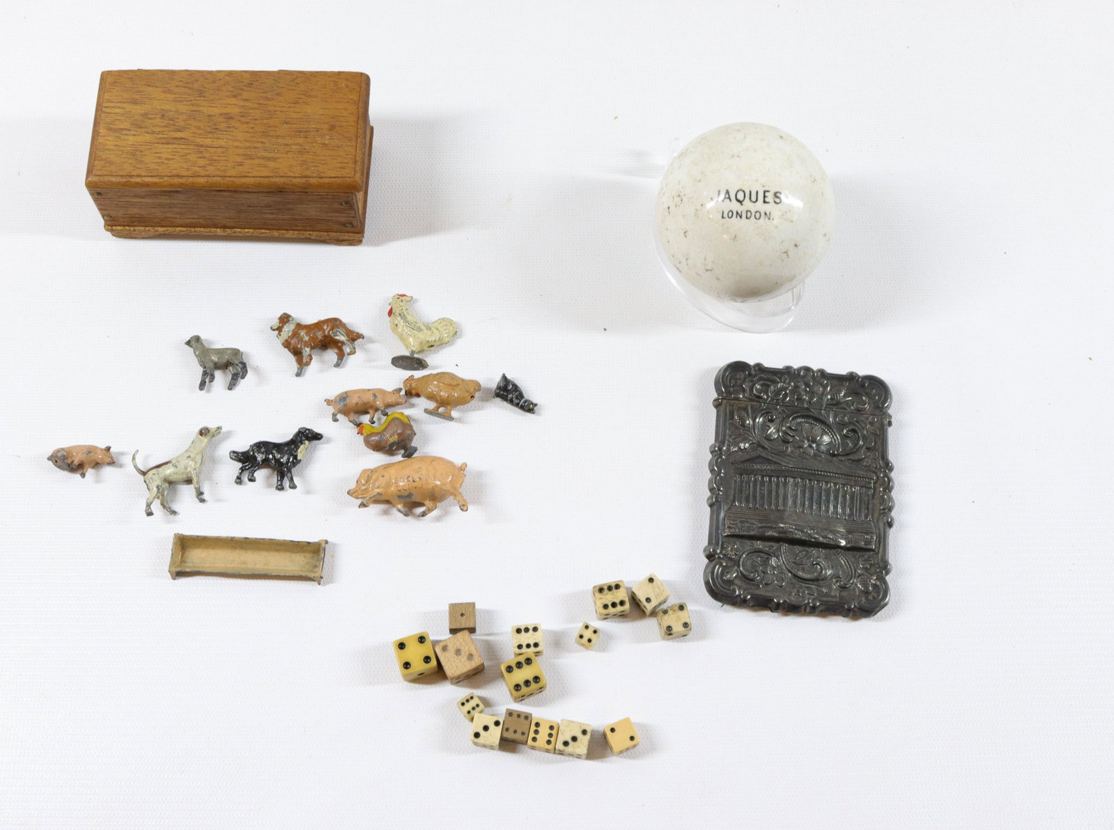 GROUP LOT OF VINTAGE SMALLS: INCLUDING: GROUP OF EARLY DICE, SILVER PLATE MATCH HOLDER, BALL MRKD. JAQUES LONDON AND SMALL CHEST WITH PAINTED CAST METAL FARM ANIMALS Size: