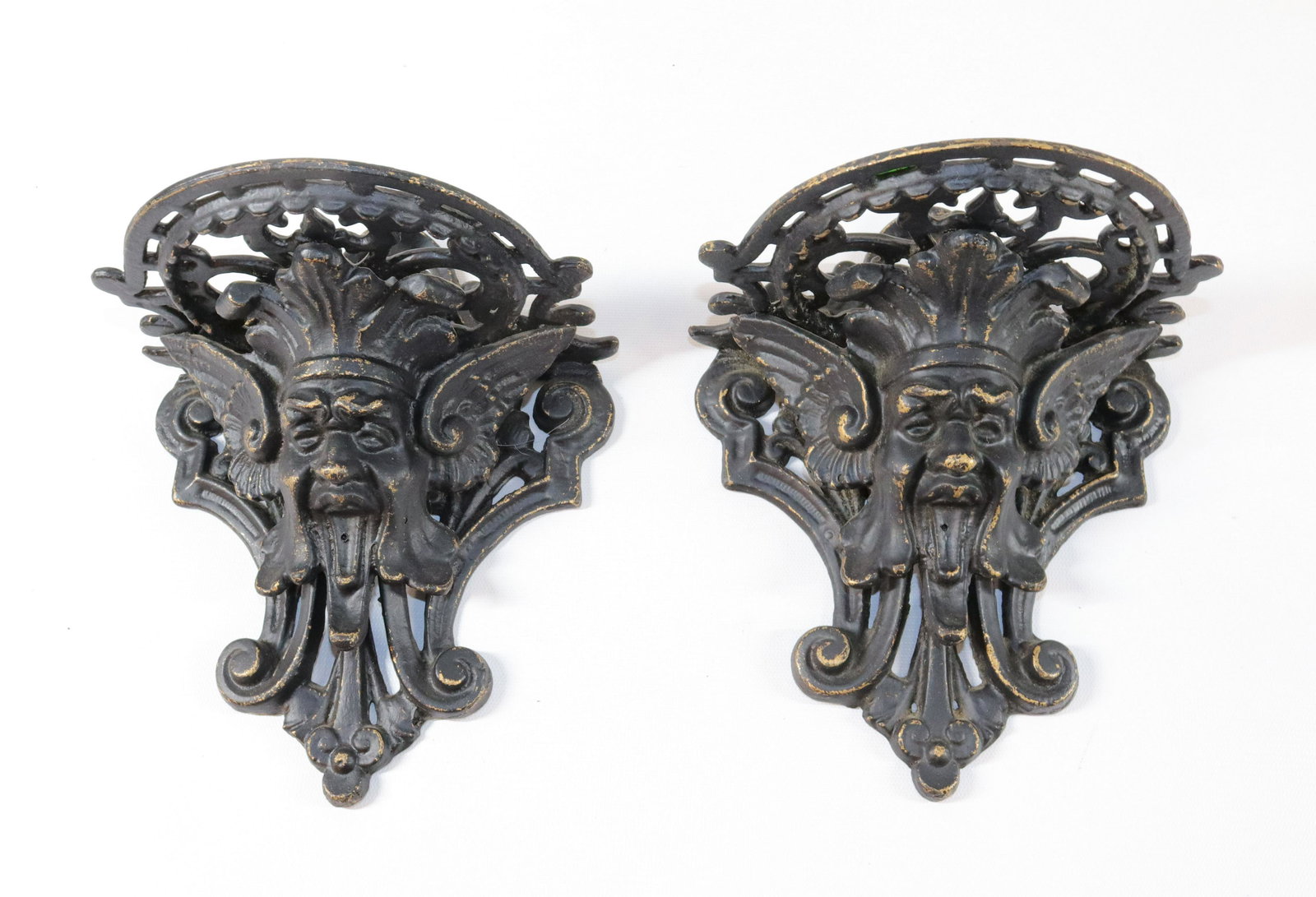 PR. OF CAST IRON WALL SHELVES: PR. OF ORNATE PAINTED WALL SHELVES WITH "NORTH WIND" DESIGN - BLACK AND GOLD PAINT Size: 9" X 5 1/2"