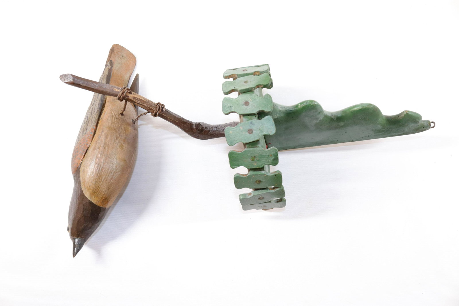 FOLK ART CARVED BIRD WALL PLAQUE: CARVED AND PAINTED BIRD WITH WIRE LEGS ON BRANCH - GREEN SHELF SUPPORT Size: 18" L