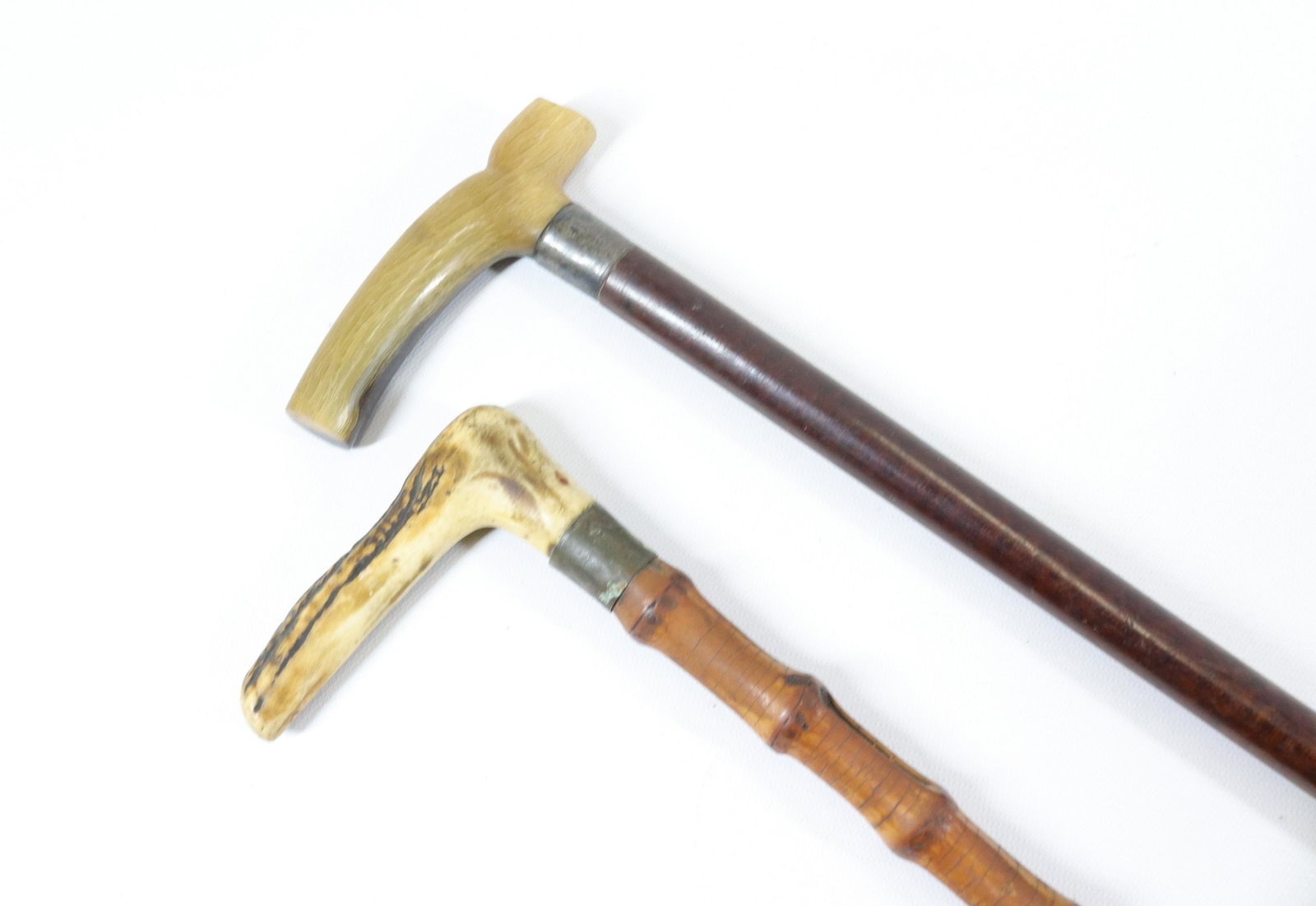 PR. OF ANTIQUE CANES: ONE WITH ANTLER GRIP AND BAMBOO SHAFT - HORN GRIP WITH STERLING SILVER BAND AND MALACCA SHAFT Size: 36" L