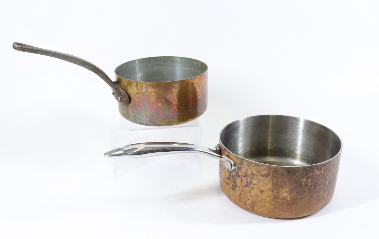 PAIR OF COPPER POTS: ONE WITH IRON HANDLE AND ONE WITH STAINLESS HANDLE. SMALLER MRKD. FRANCE 6 1/2" AND 7 1/4" D