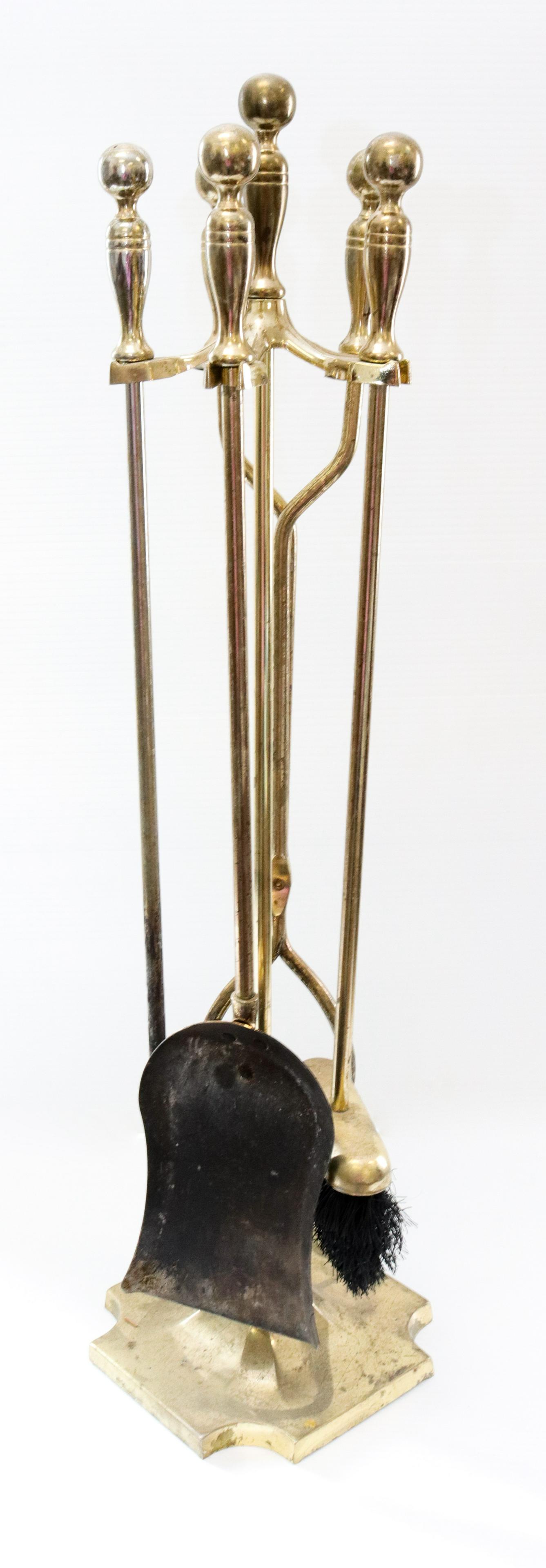 Brass fireplace tool set: Description: Shovel, tongs, brush, and poker - on stand Condtion: Wear consistent with age and use Size: 30" H Consignor: JS Terms: This is an On-Site Online Only Auction. Preview Will Be (2) Days