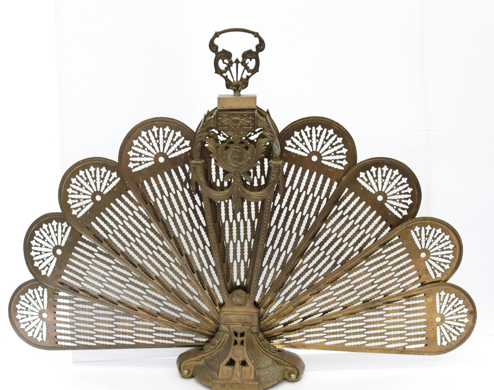 Fold-up brass fireplace screen: Description: Pressed brass with christopher columbus motif Condtion: Wear consistent with age and use Size: 27 1/2" X 40" (FANNED OUT) Consignor: JS Terms: This is an On-Site Online Only Auction.