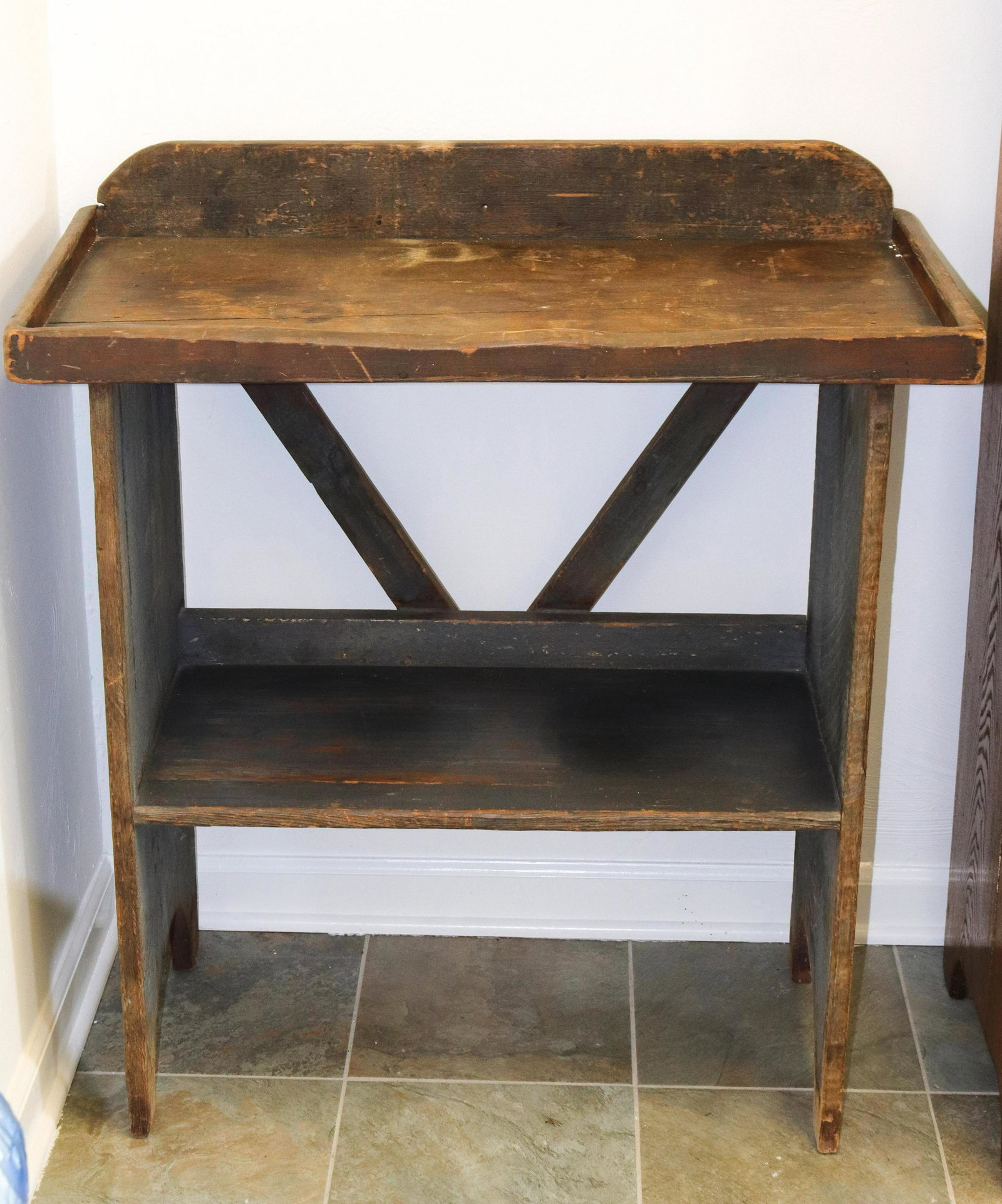 Painted wooden bucket bench: Description: Multi color painted surface - with cut out legs and lip around top Condtion: Normal wear from age and use Size: 36 1/2" X 33 1/4" X 17" Consignor: JS Terms: This is an On-Site Online