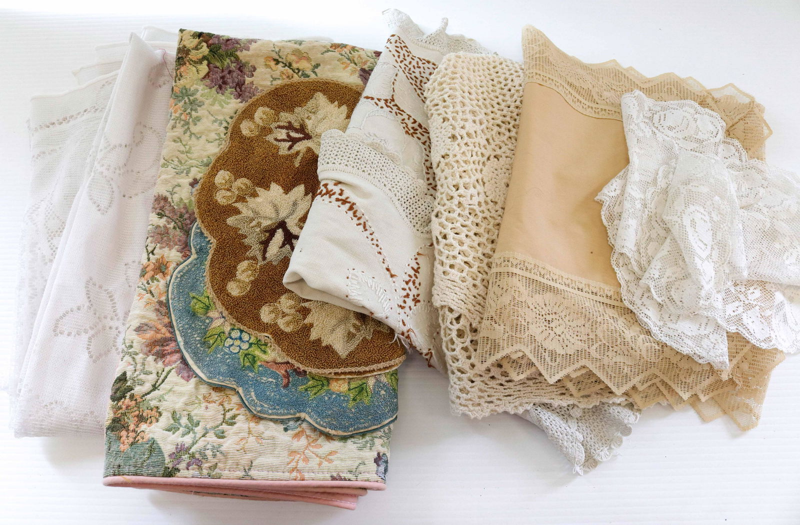 Group lot of textiles: Description: Including - tablecloths, table runners, doilies, and more Condtion: Wear consistent with age and use Size: Consignor: JS Terms: This is an On-Site Online Only Auction. Preview Will B