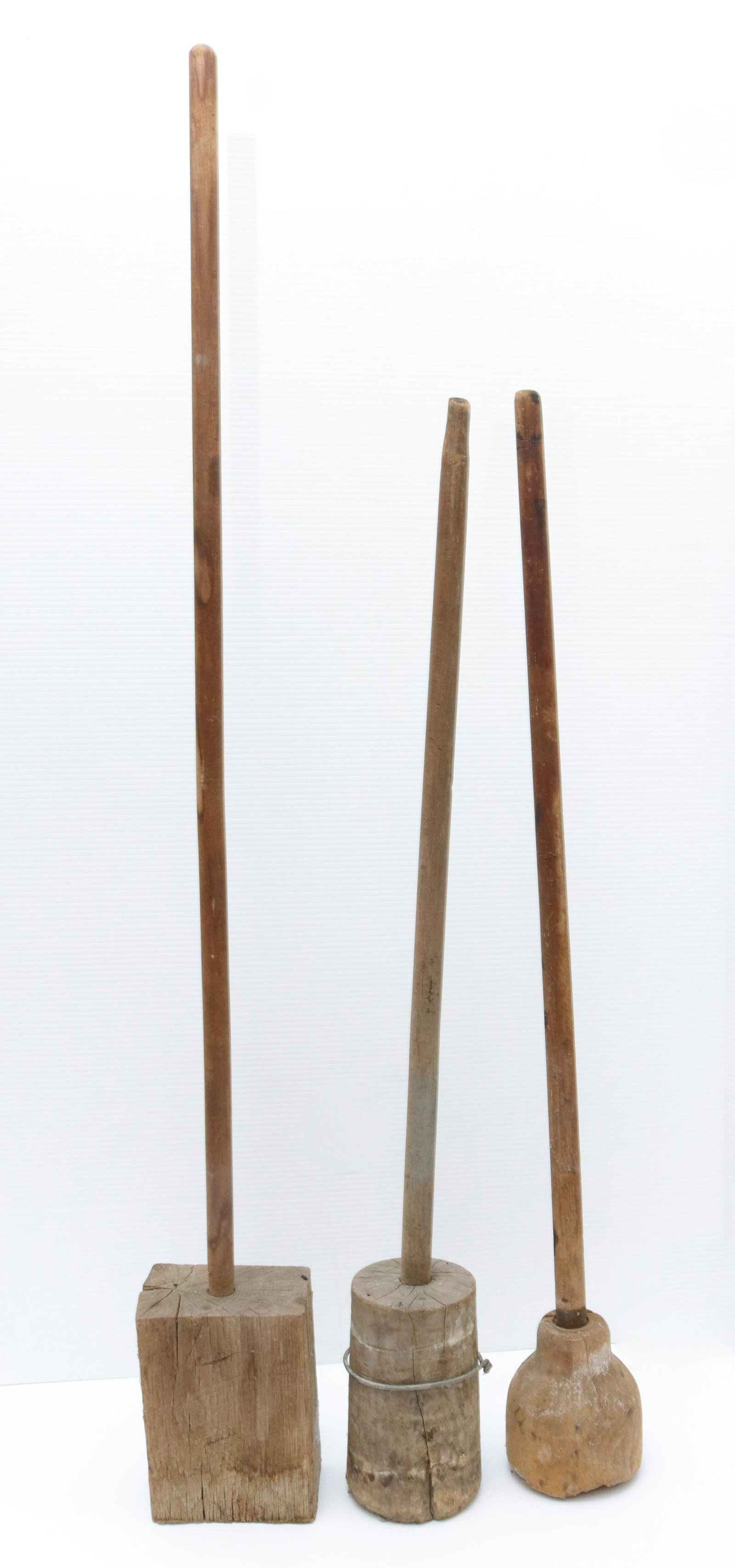 Antique wooden stomper lot: Description: (3) primitive wooden sauerkraut stompers Condtion: As found Size: TALLEST 48" Consignor: JS Terms: This is an On-Site Online Only Auction. Preview Will Be (2) Days and you must Make