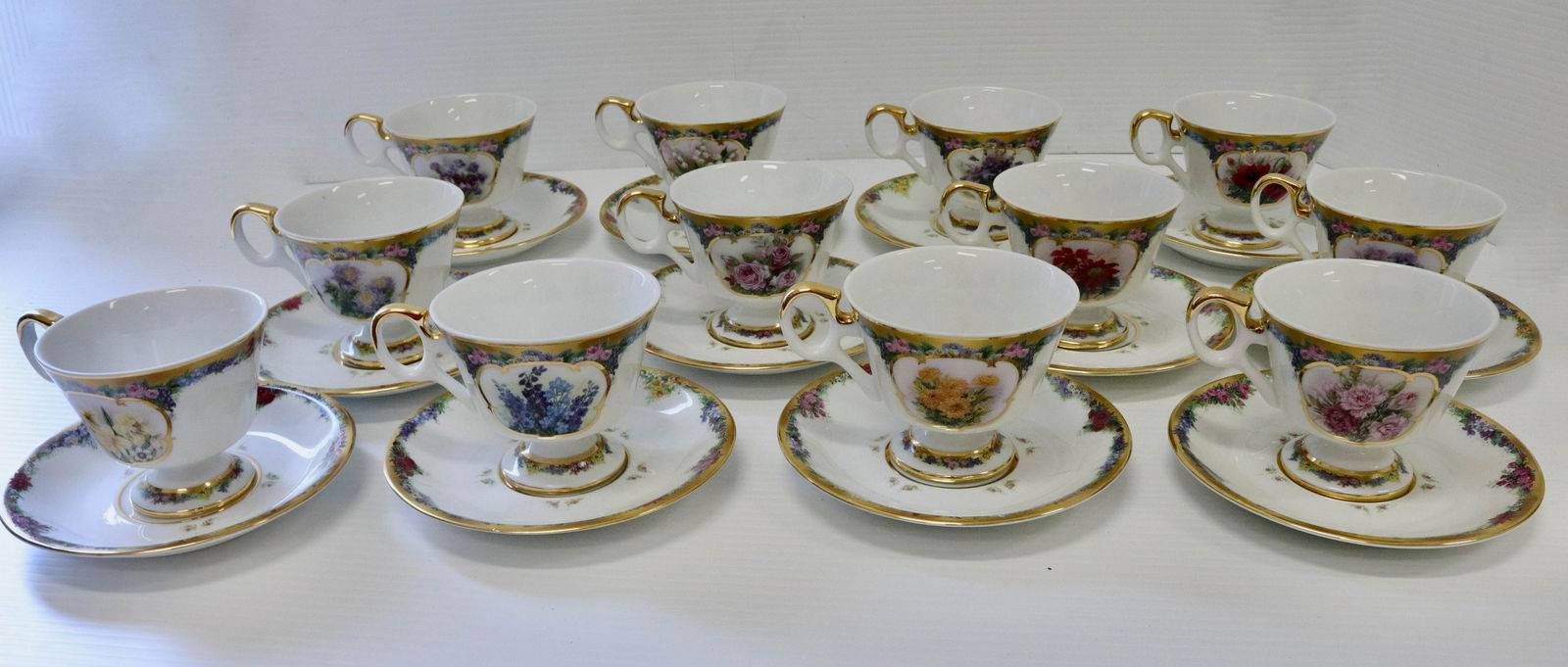 Flower of the month tea cup set: Description: Set of (12) bradford editions flower of the month club - cups and saucers Condtion: Good overall condition Size: Consignor: JS Terms: This is an On-Site Online Only Auction. Preview