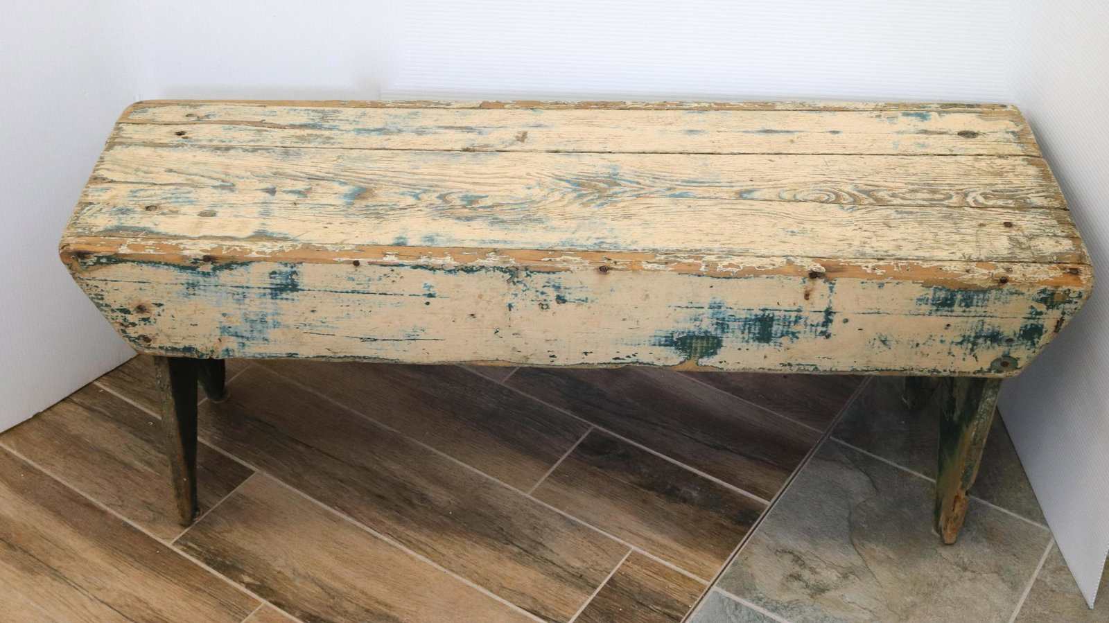 Green primitive bench: Description: Painted primitive bench with boot jack ends - green and cream paint Condtion: Wear to painted surface Size: 17" X 42" X 13" Consignor: JS Terms: This is an On-Site Online Only Auction.