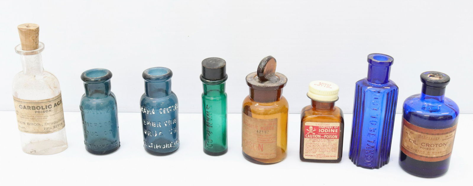 Group lot of early poison bottles: Description: (8) bottles including - (2) cobalt blue poison bottles, (3) poison bottles with paper labels, and (2) teal bromo seltzer bottles Condtion: Wear consistent with age and use Size: 2 1/4" TO