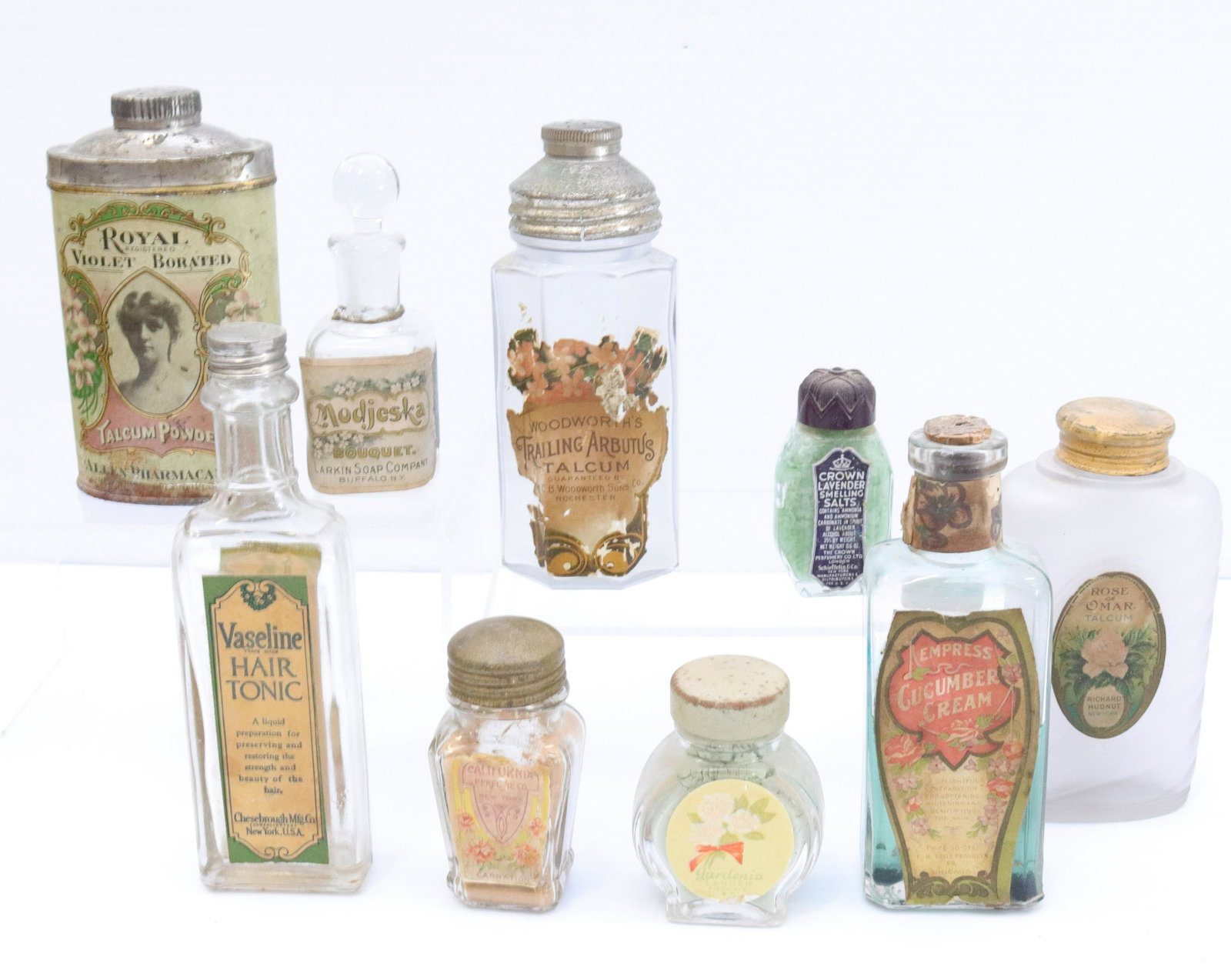 Group lot of bathroom product bottles: Description: (9) vintage bottles including - rose of omar talcum, cucumber cream, vaseline hair tonic, royal violet powder tin, and more Condtion: Wear consistent with age and use Size: 2 1/2" TO 6" C