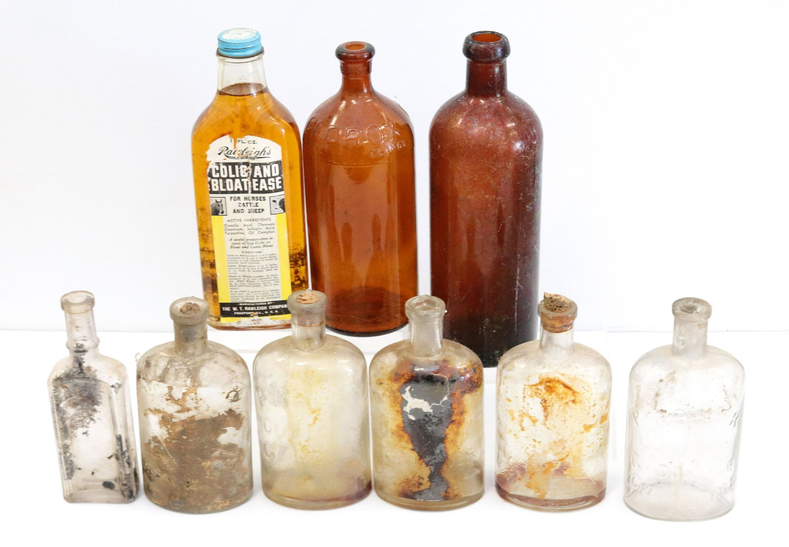 Group lot of vintage bottles: Description: (9) glass bottles including (2) amber Condtion: Wear consistent with age and use Size: 6" TO 9" H Consignor: JS Terms: This is an On-Site Online Only Auction. Preview Will Be (2) Days