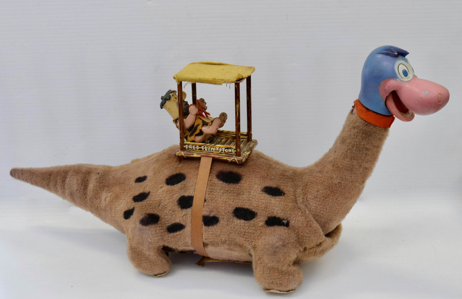 Marx "dino the dinosaur" battery operated toy: Description: 1960's marx fred flintstone riding dino toy Condtion: Some losses at top of neck - unsure if works Size: 11" X 23" Consignor: JS Terms: This is an On-Site Online Only Auction. Previe
