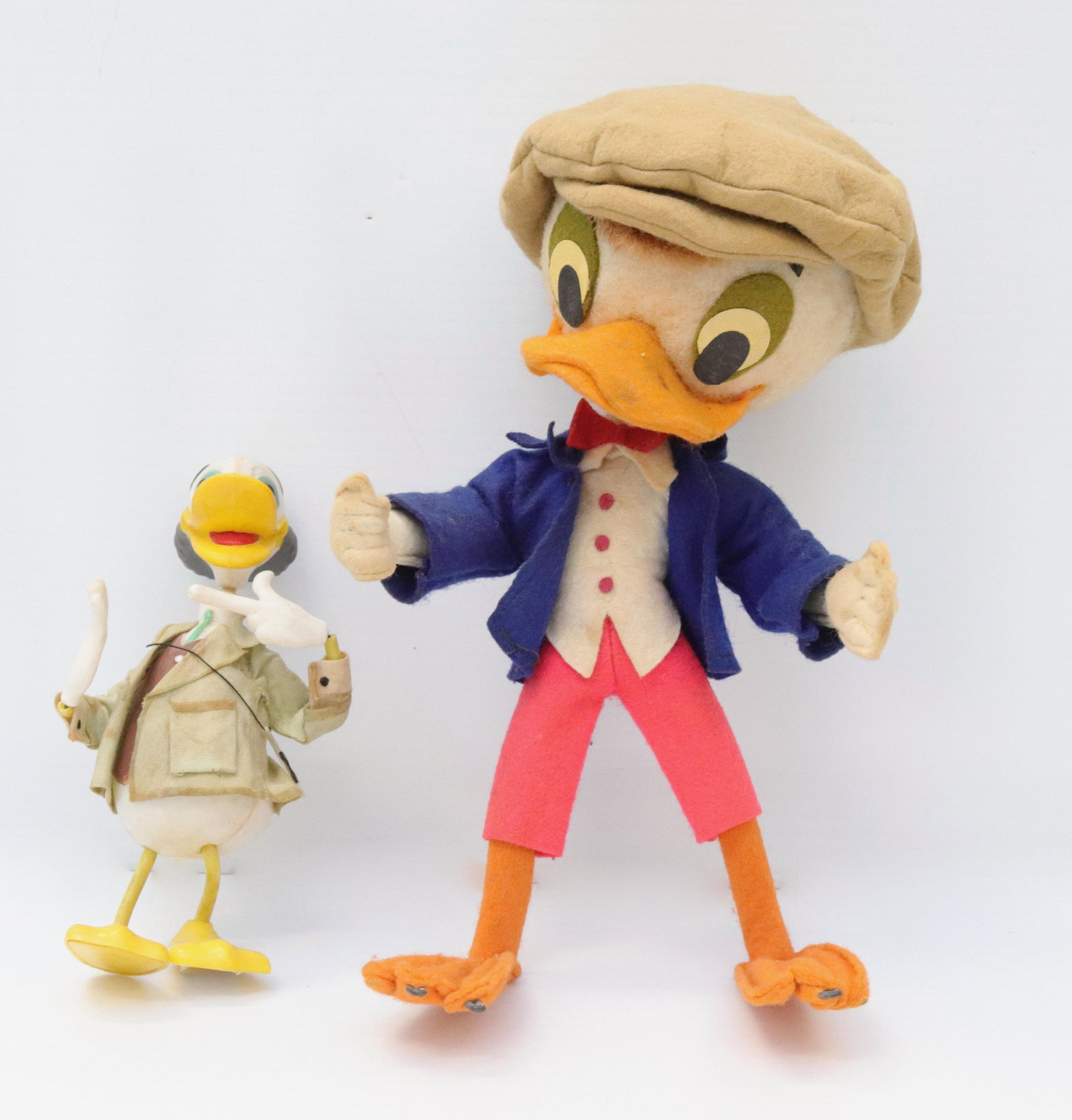 Pair of cartoon character ducks: Description: Marx scrooge duck and larger felt duck with hat Condtion: Wear from age and use. some fade and discoloration Size: 6" TO 9 1/4" H Consignor: JS Terms: This is an On-Site Online Only Auc