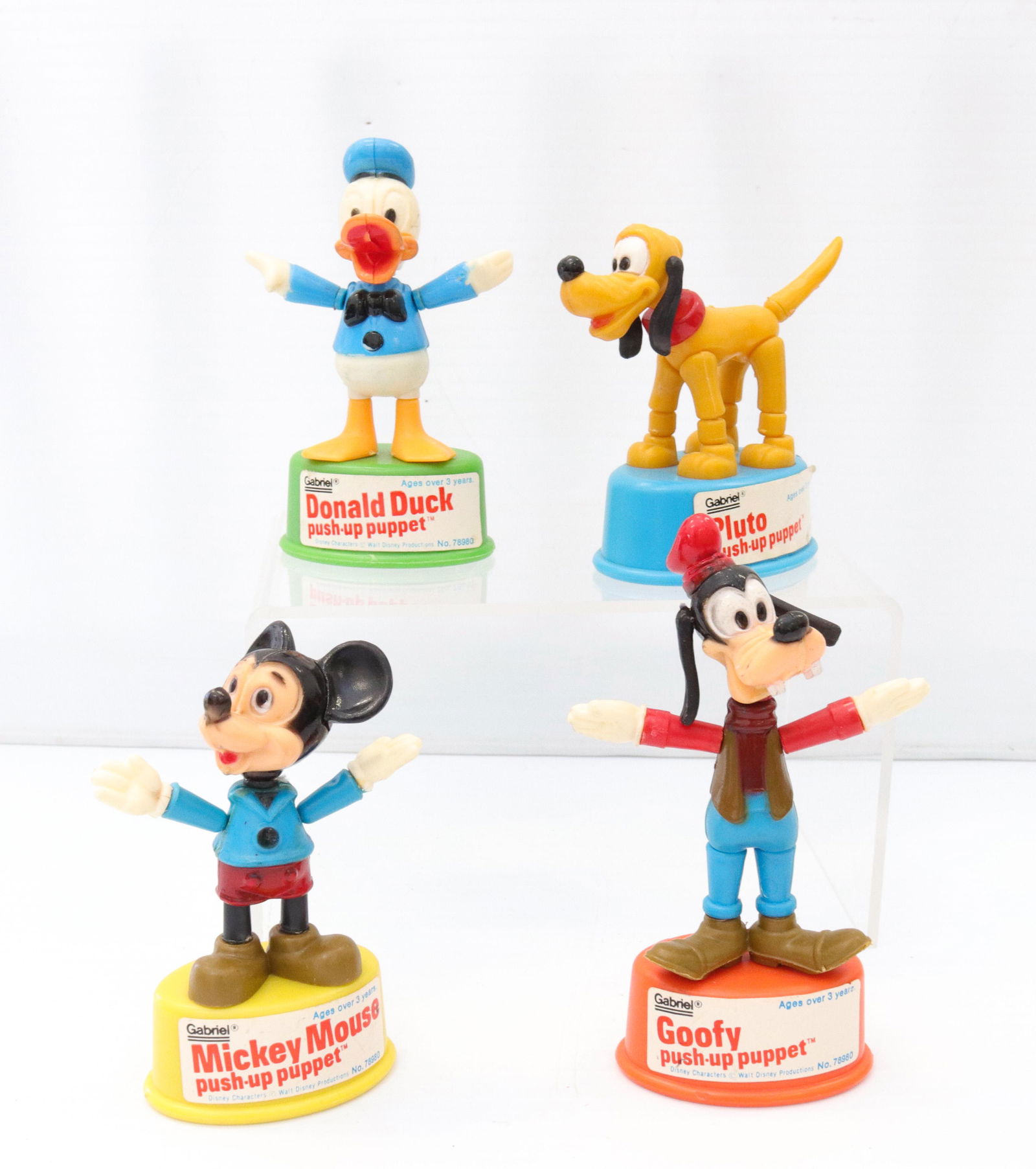 Gabriel push-up puppet lot: Description: Circa 1977 - walt disney productions including - donald duck, mickey mouse, goofy, and pluto Condtion: Wear consistent with age and use Size: 3" TO 4 1/4" H Consignor: JS Terms: This i